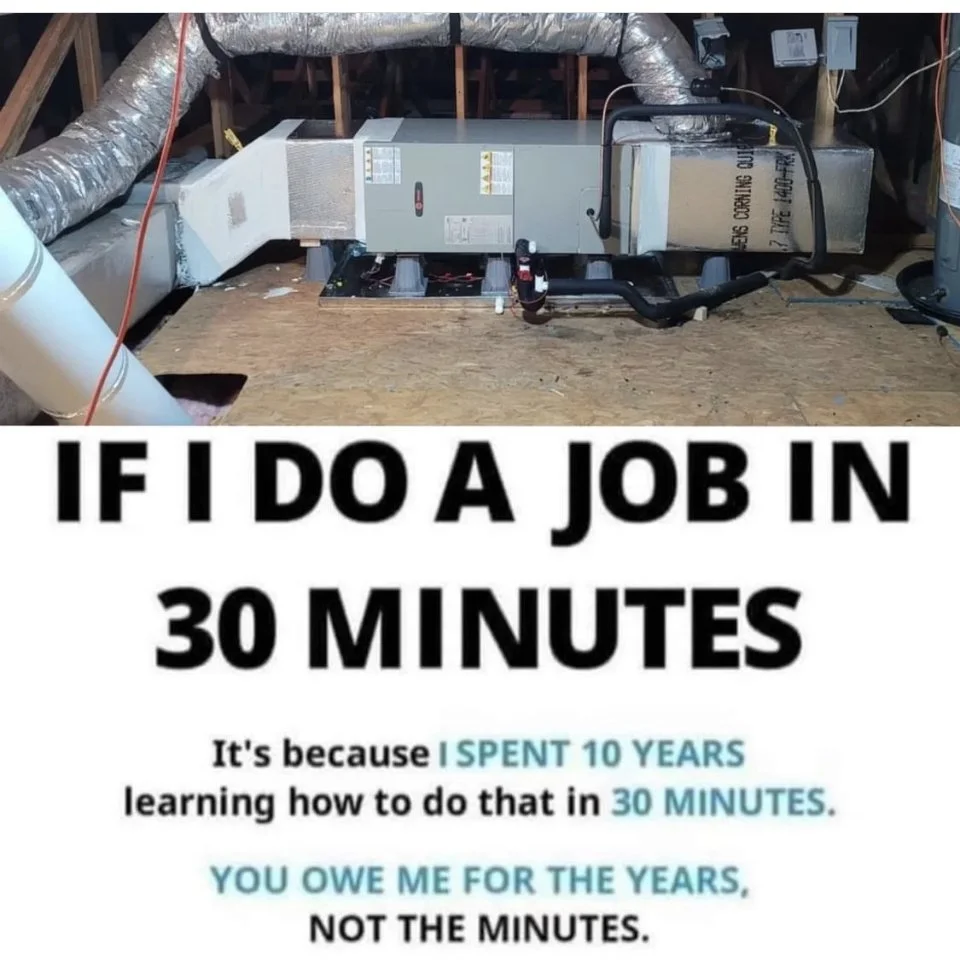 Insulation and ductwork in an attic space, with a furnace or HVAC system installed.