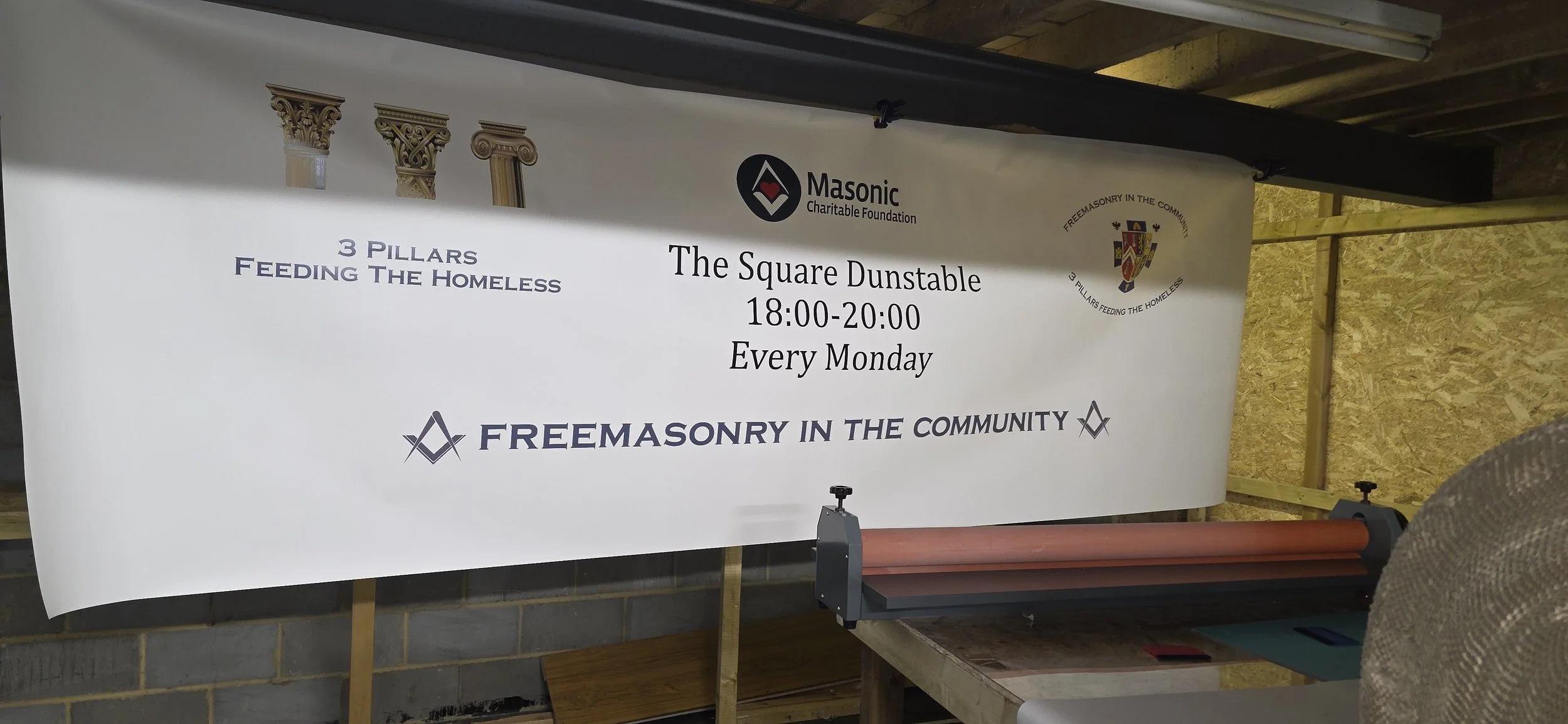 A banner advertising a community event called The Square Dunstable, organized by Freemasonry in the Community, scheduled every Monday from 6 to 8 pm at 18:00-20:00.