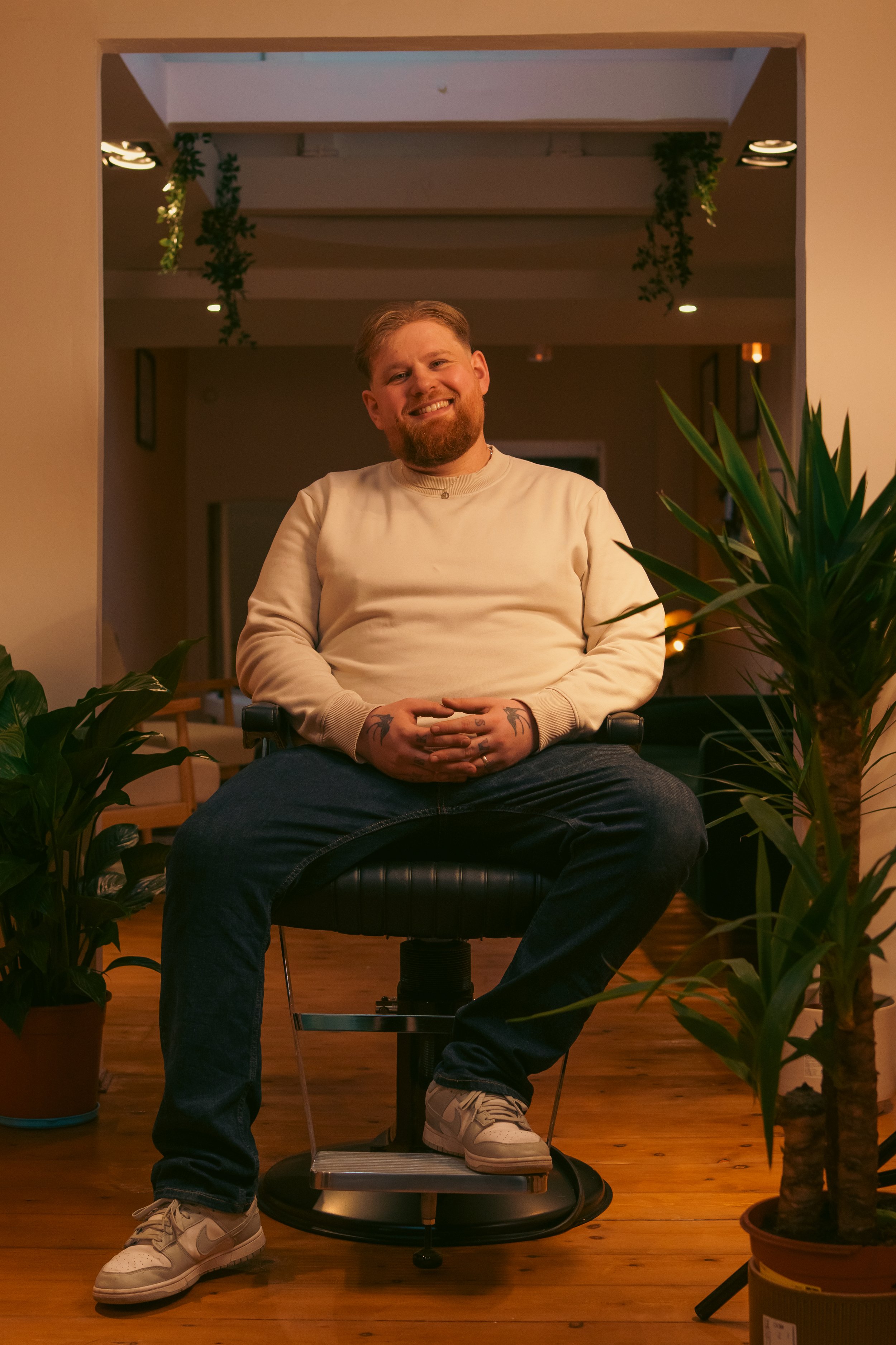 director, founder and barber of Parea London Dale, sat in a barber chair in his barbershop