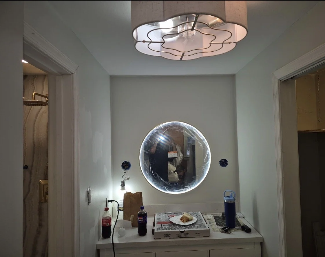 Bathroom light and mirror installation.