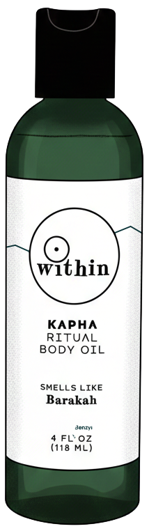 Bottle of Within Kapha Ritual Body Oil with green and white label, black cap, and scent described as Barakah.