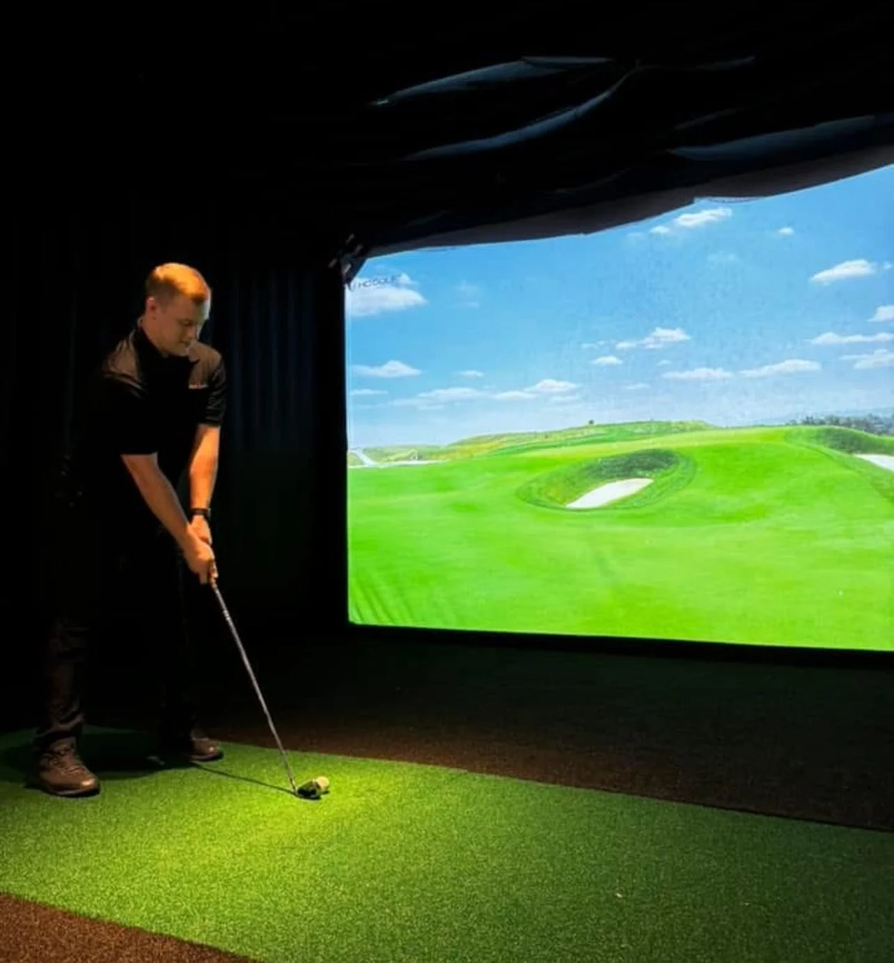 Tap that Sports man playiing golf on simulator