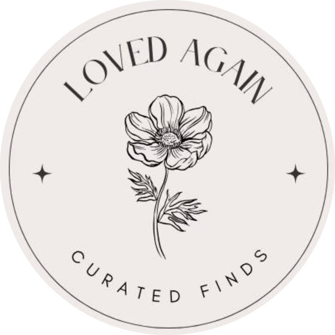 A circular logo with a line drawing of a flower in the center. The text around the circle reads 'Loved Again' at the top and 'CuraTed Finds' at the bottom, with two small star symbols on either side.