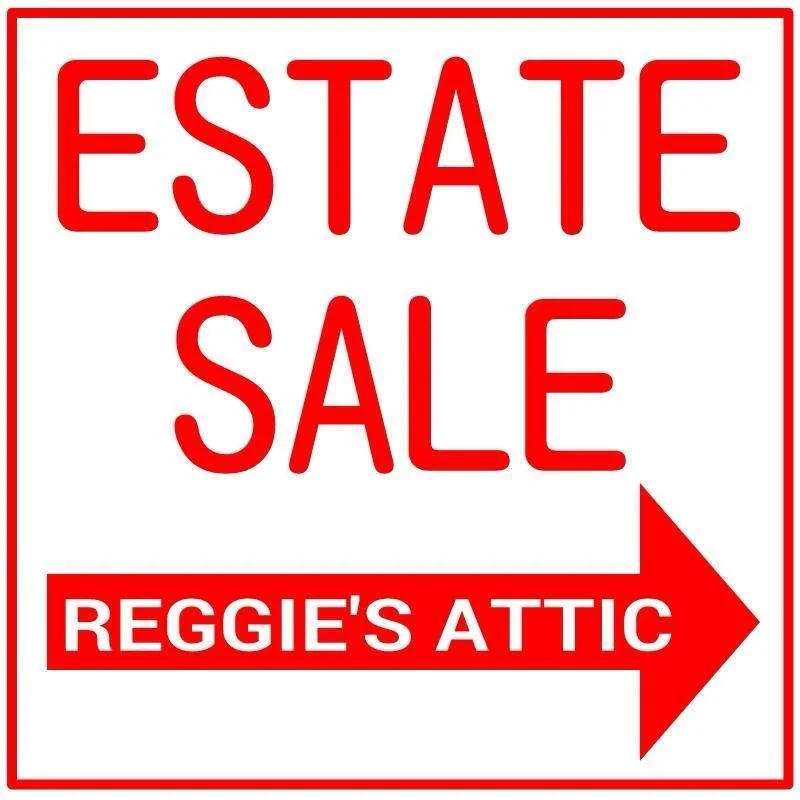 A red and white sign advertising an estate sale at Reggie's Attic, with a large red arrow pointing to the right.