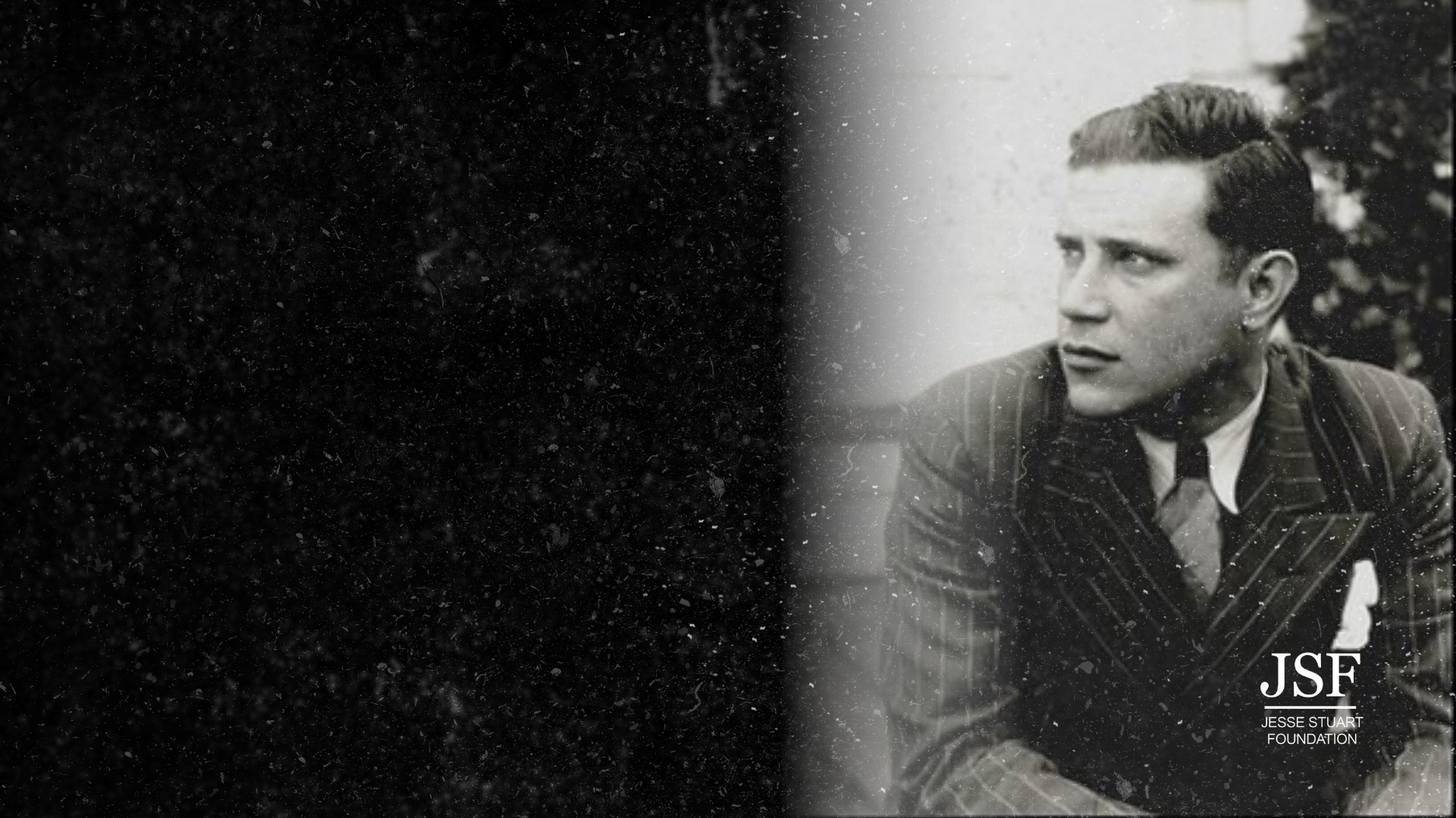 Black and white photo of a young man in a pinstripe suit sitting outdoors, looking to the side. The Jesse Stuart Foundation logo with the initials 'JSF' is at the bottom right corner.