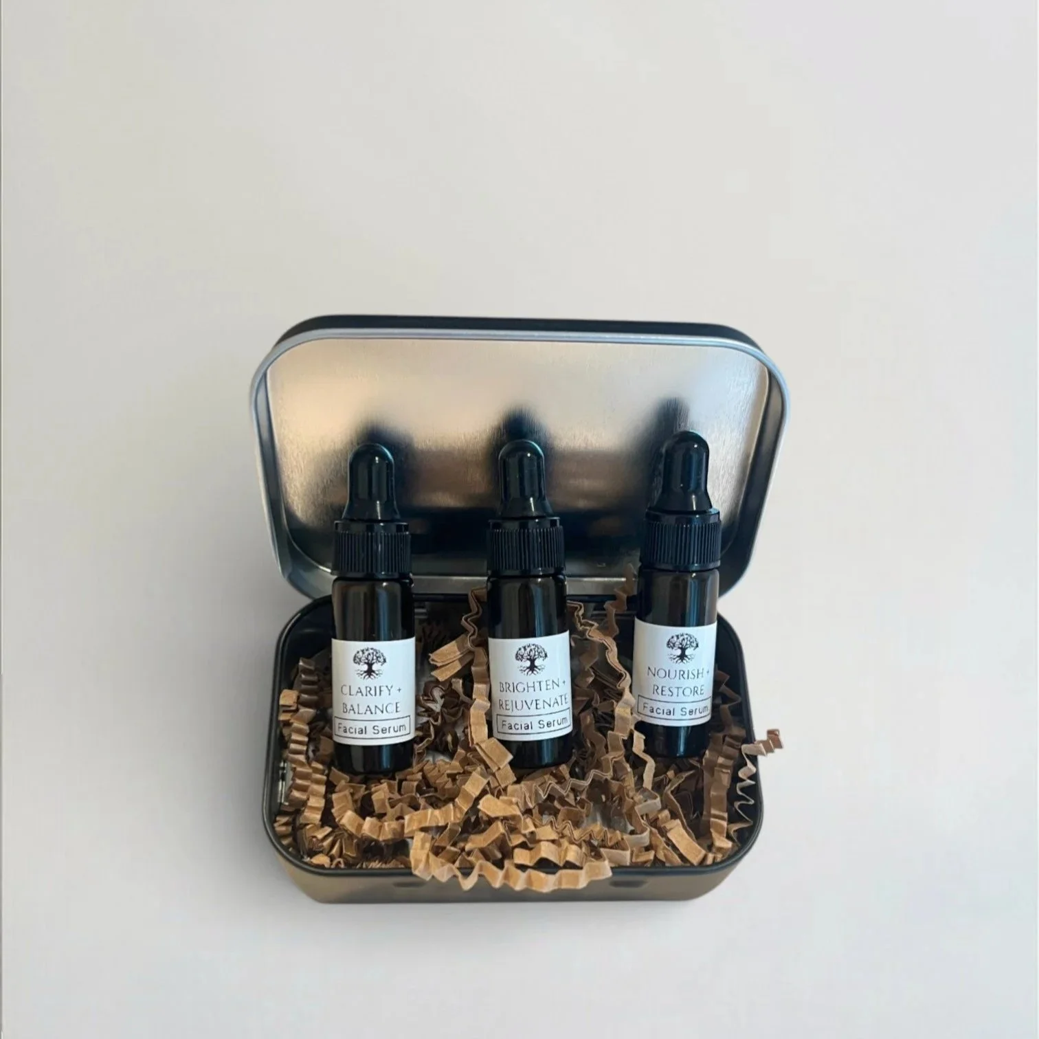 facial oil samples in black tin box for congested, dull, or mature skin