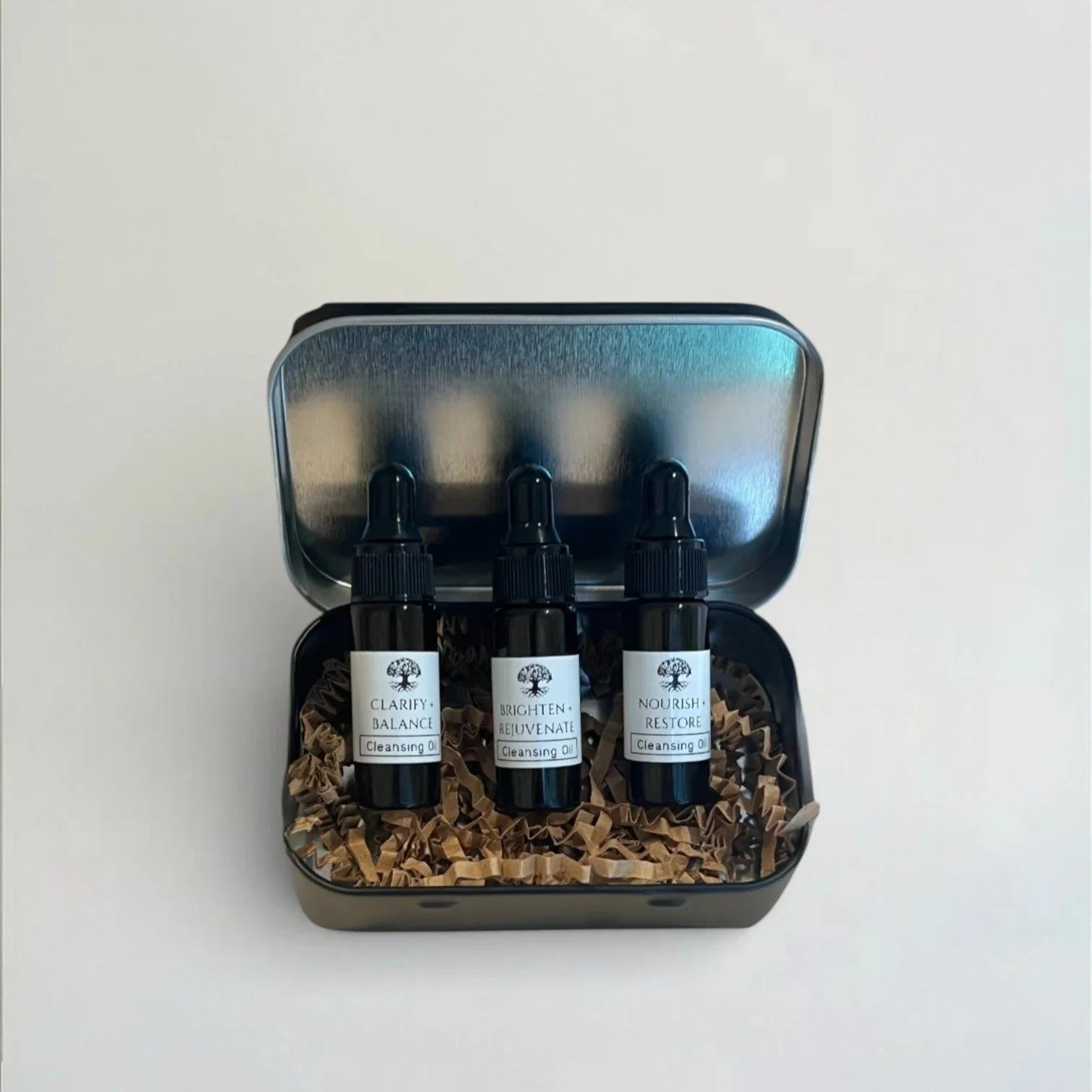 cleansing oil discovery kit in a black travel tin box