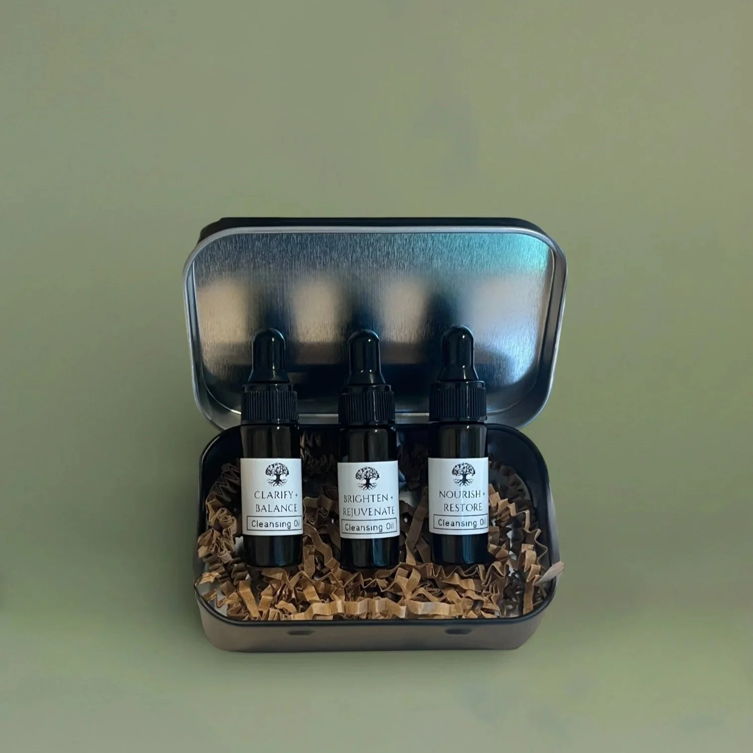 Cleansing Oil Travel Set including 3 vials of different facial oils in a metal tin