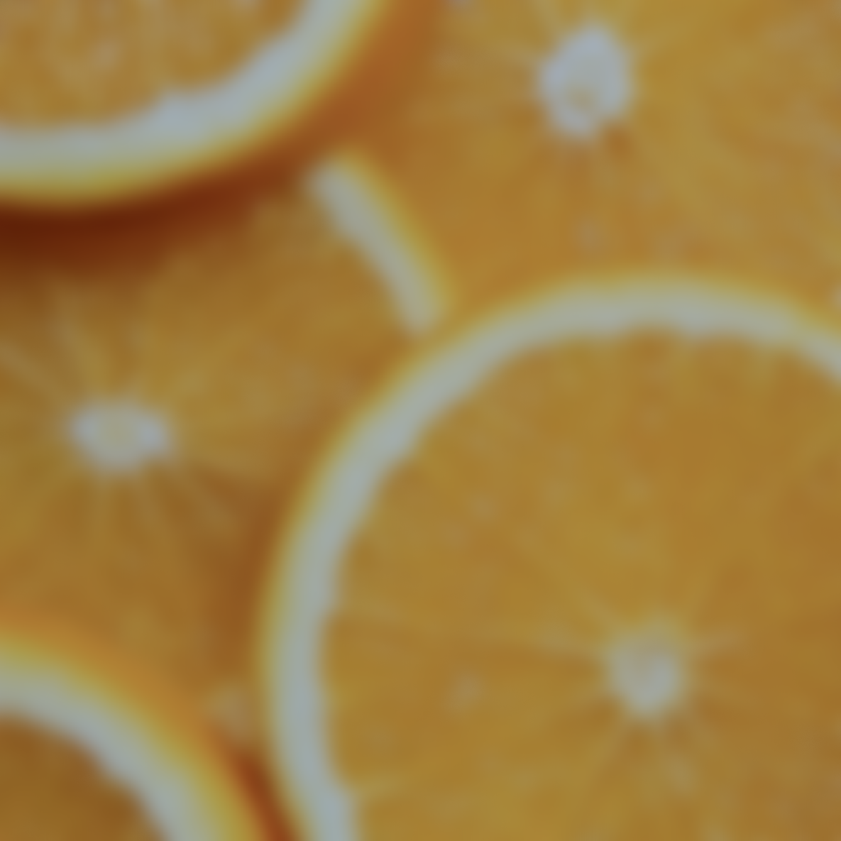 photo of out of focus orange slices with skin benefits for a vitamin c + antioxidant facial oil