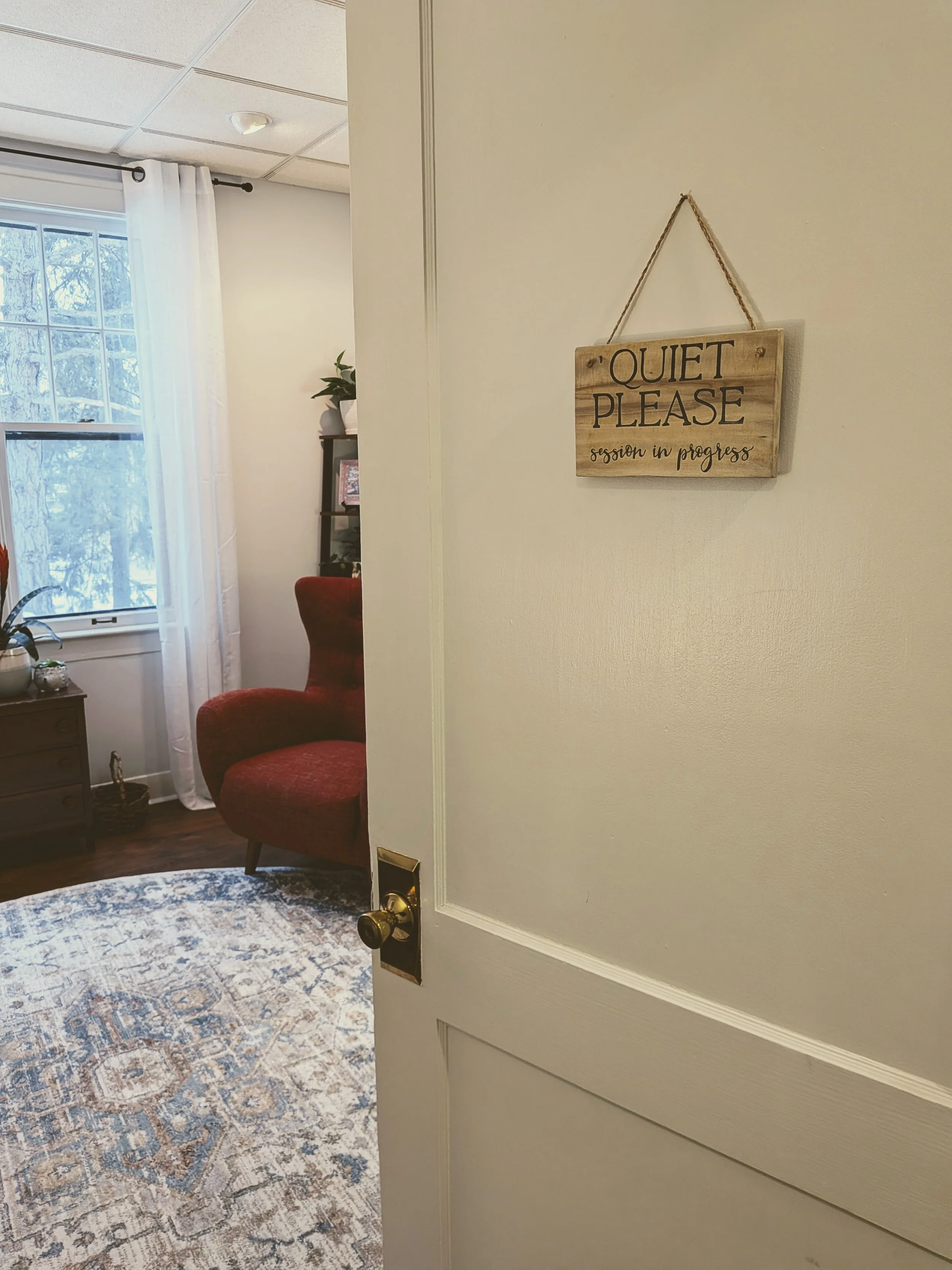 A sign hangs on the door of Irene Kraegel's therapy office, reading "Quiet Please, Session in Progress." In-person therapy available in East Grand Rapids for anxiety, depression, and chronic pain, with optional Christian integration.