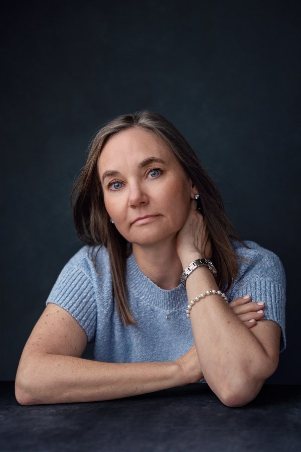 Dr. Irene Kraegel offers treatment for chronic pain in-person in East Grand Rapids, MI and online in 43 PsyPact states. Photo shows Dr. Kraegel smiling with light brown hair and blue eyes and wearing a light blue short sleeve sweater.
