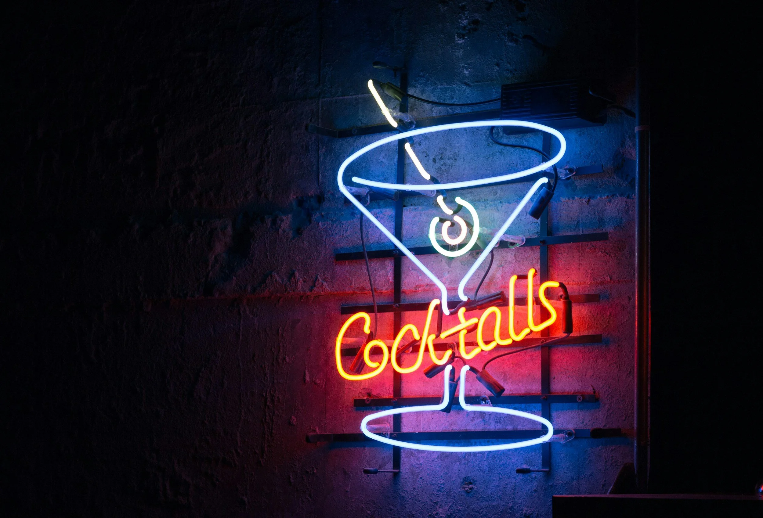 Neon sign with a martini glass and the word 'Cocktails' in bright colors.