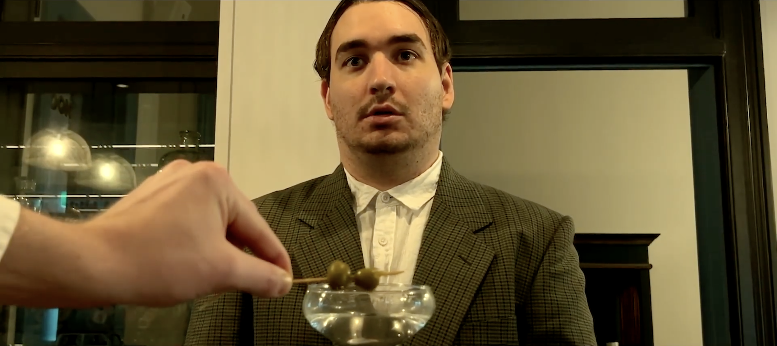 THREE OLIVES

"Three Olives" is a darkly comic short set in an elegant bar where silence and social anxiety rule. It follows a painfully conflict-averse bartender and a fragile customer whose simple request for a dry martini with three olives spirals