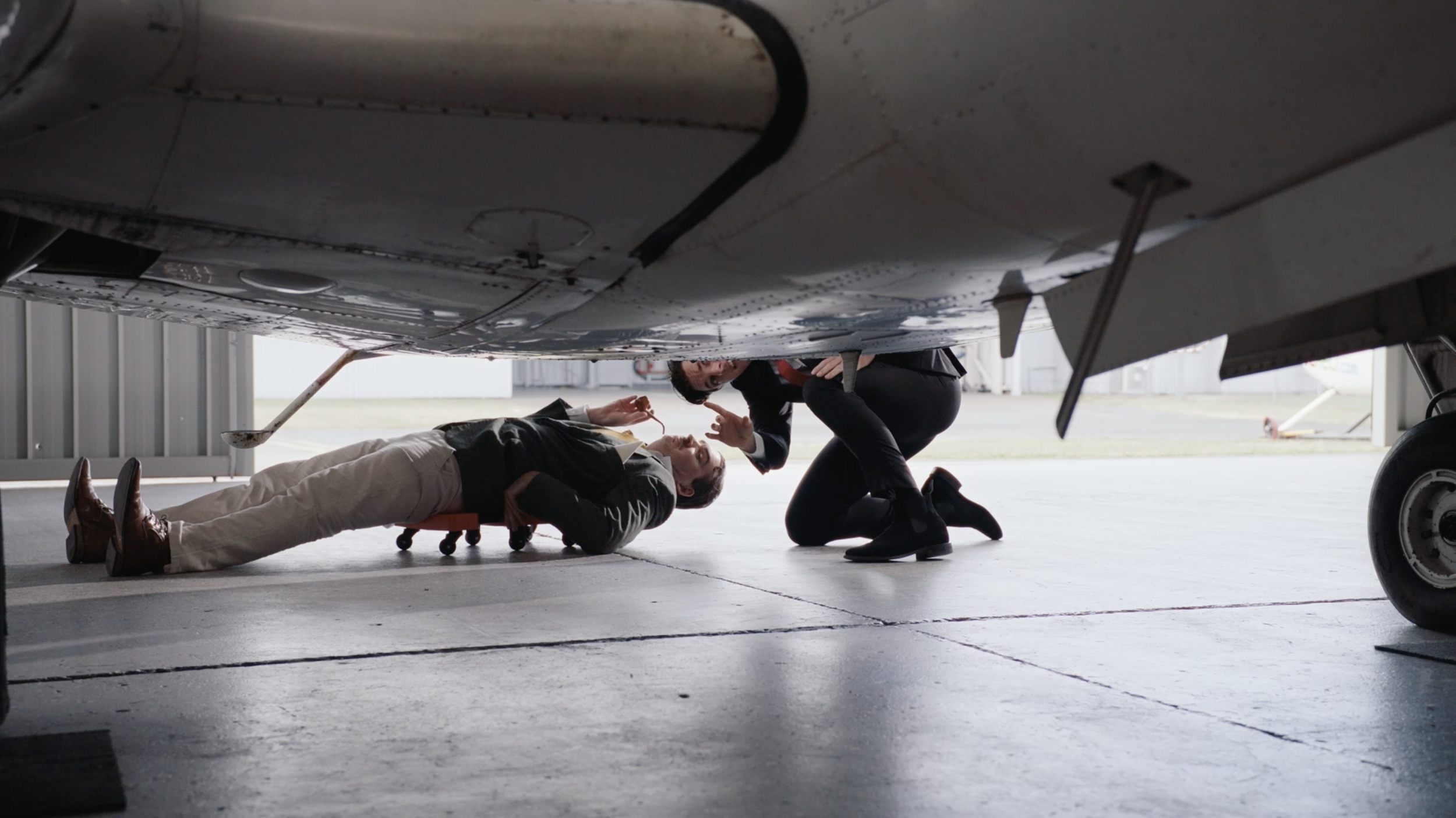 CLIVE´S JET

In a private hangar, a sleek self-important salesman and an aristocratic buyer circle around a luxury jet, competing ego for ego during an attempted sale. 