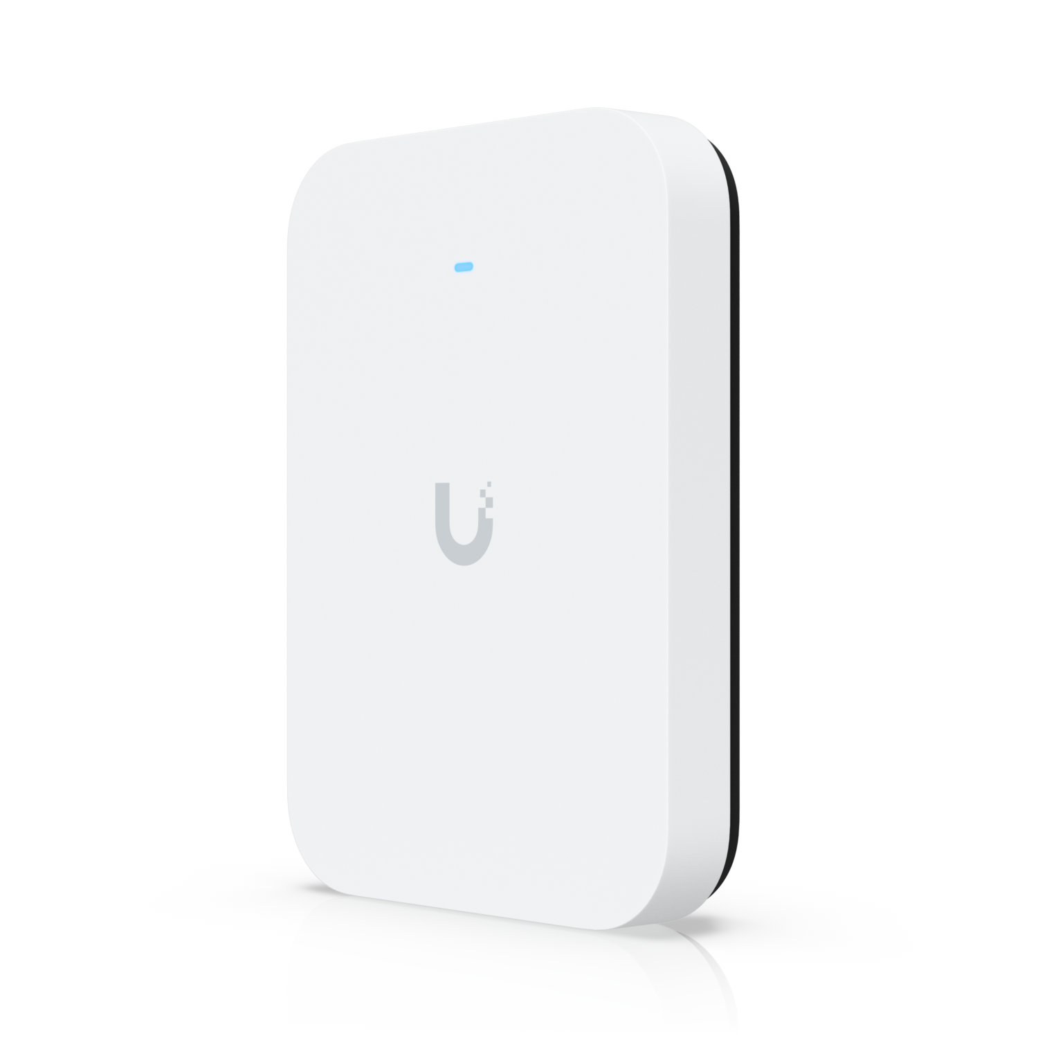A white Ubiquiti network device, rectangular with rounded edges, placed on a reflective surface against a black background.