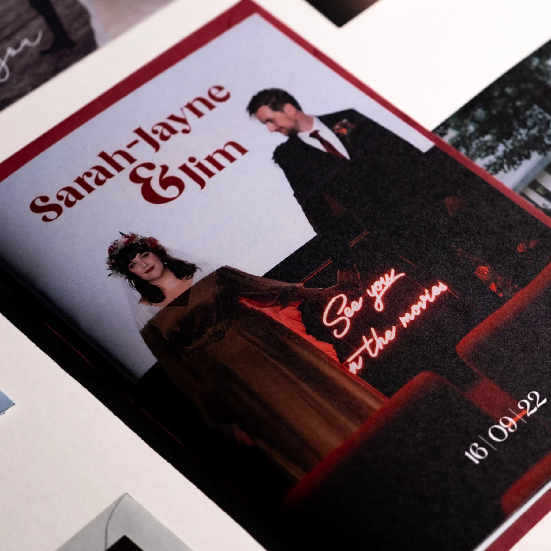 Wedding invitation featuring Sarahh-Jayne and Jim, with a photo of the couple. The woman is wearing a floral crown and the man is in a suit. The invitation includes a message saying, 'See you on the next move' and a date of 16/09/22.