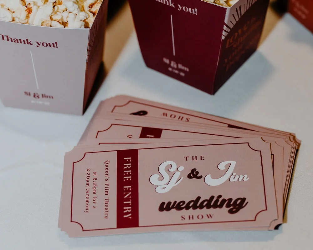 Wedding show tickets for the Si & Jim wedding, with popcorn boxes in the background.