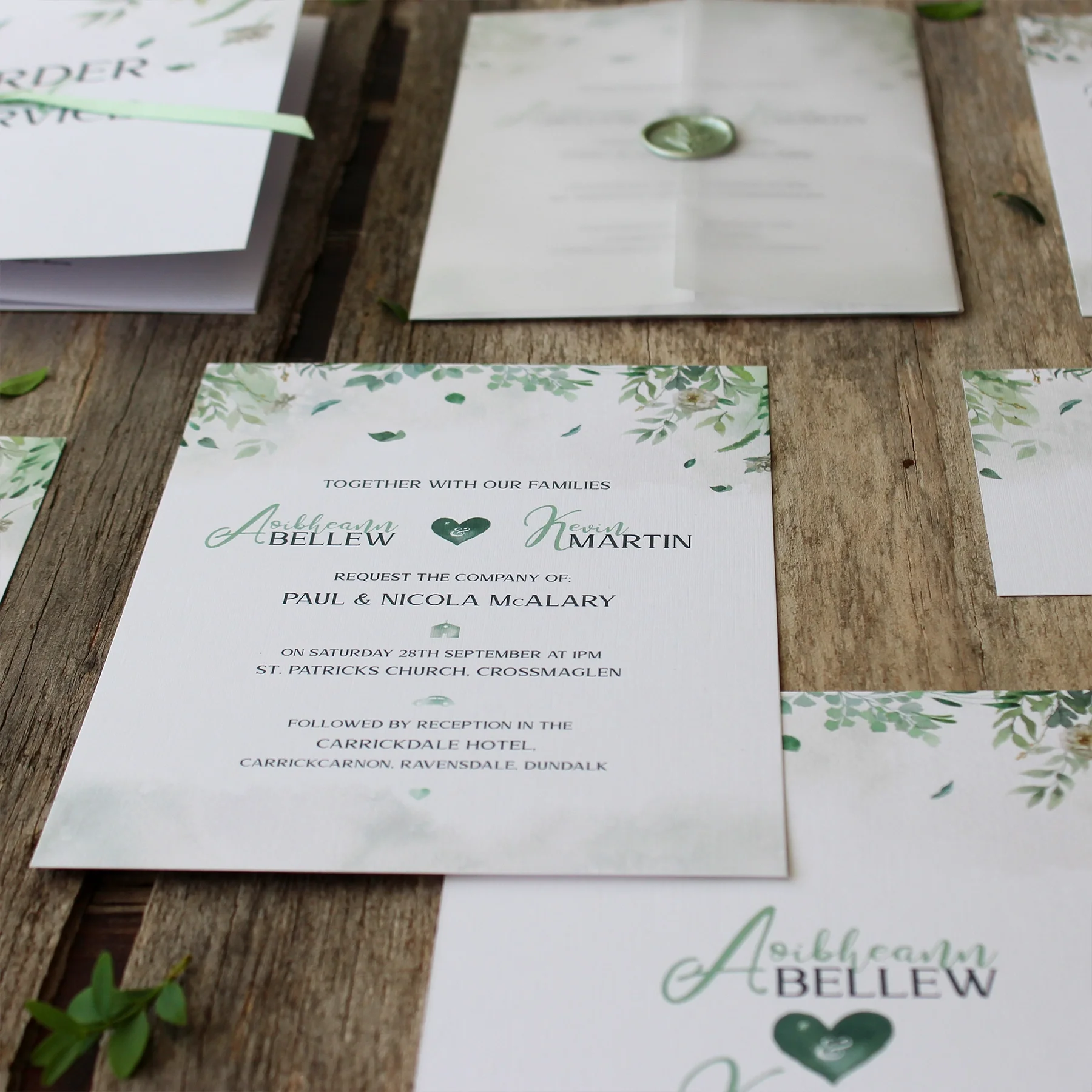 A wedding invitation with greenery and floral design, mentioning names Aoibheann Bellew and Kevin Martin, for a ceremony at St. Patrick's Church on September 28th, followed by reception at various hotels.
