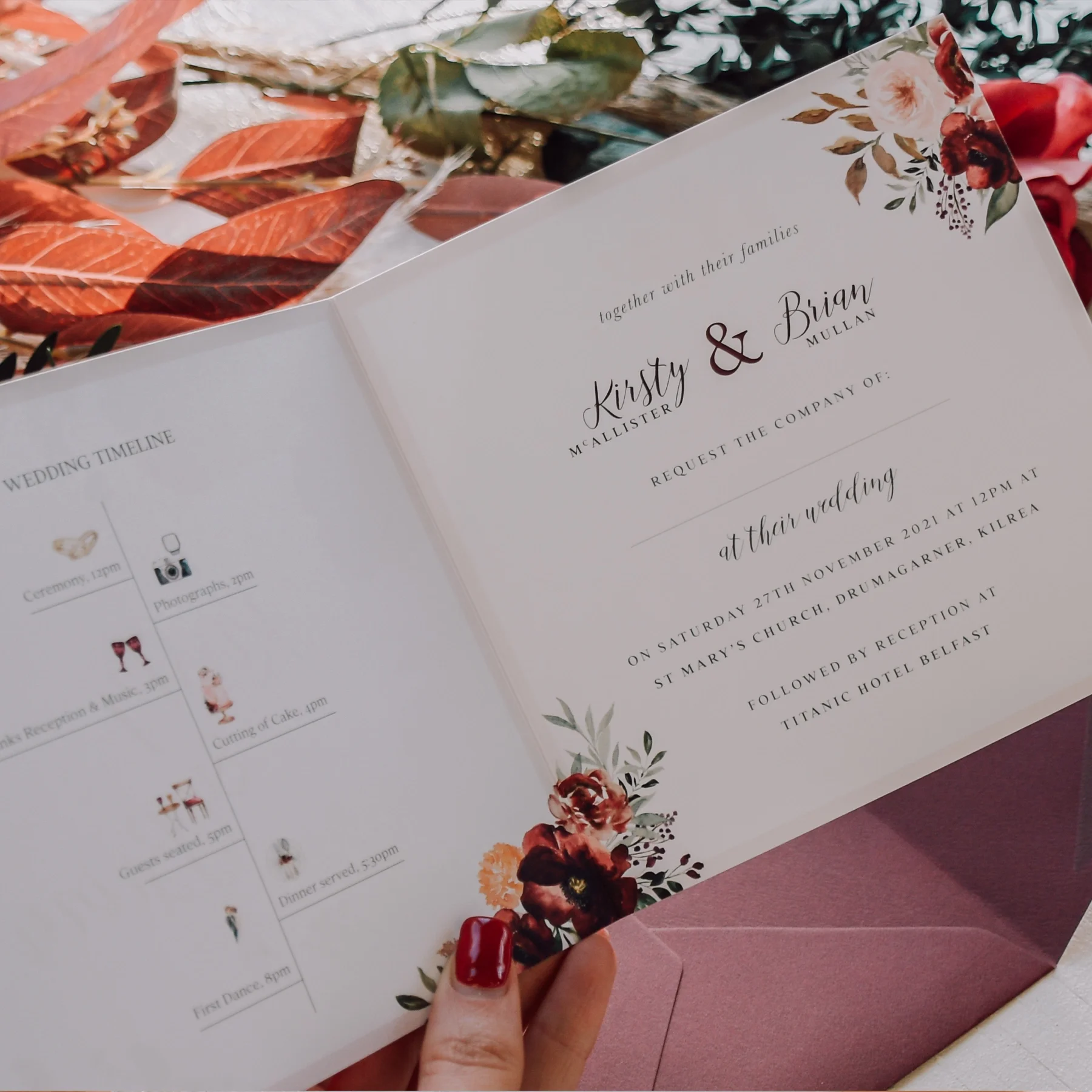 Wedding invitation with floral design, announcing the marriage of Kirsty McAllister and Brian Mullan. The ceremony is at St Mary's Church on November 27, 2021, at 12 PM, followed by reception at Titanic Hotel Belfast. The invitation features floral d