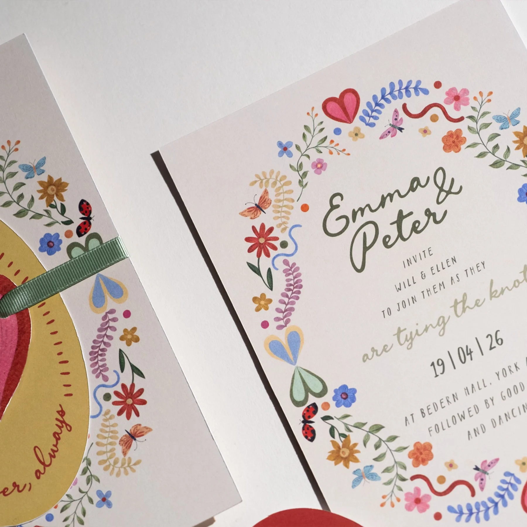 Colorful floral wedding invitation with names Emma & Peter, date 19/04/26, details about the venue at Bedern Hall, York.