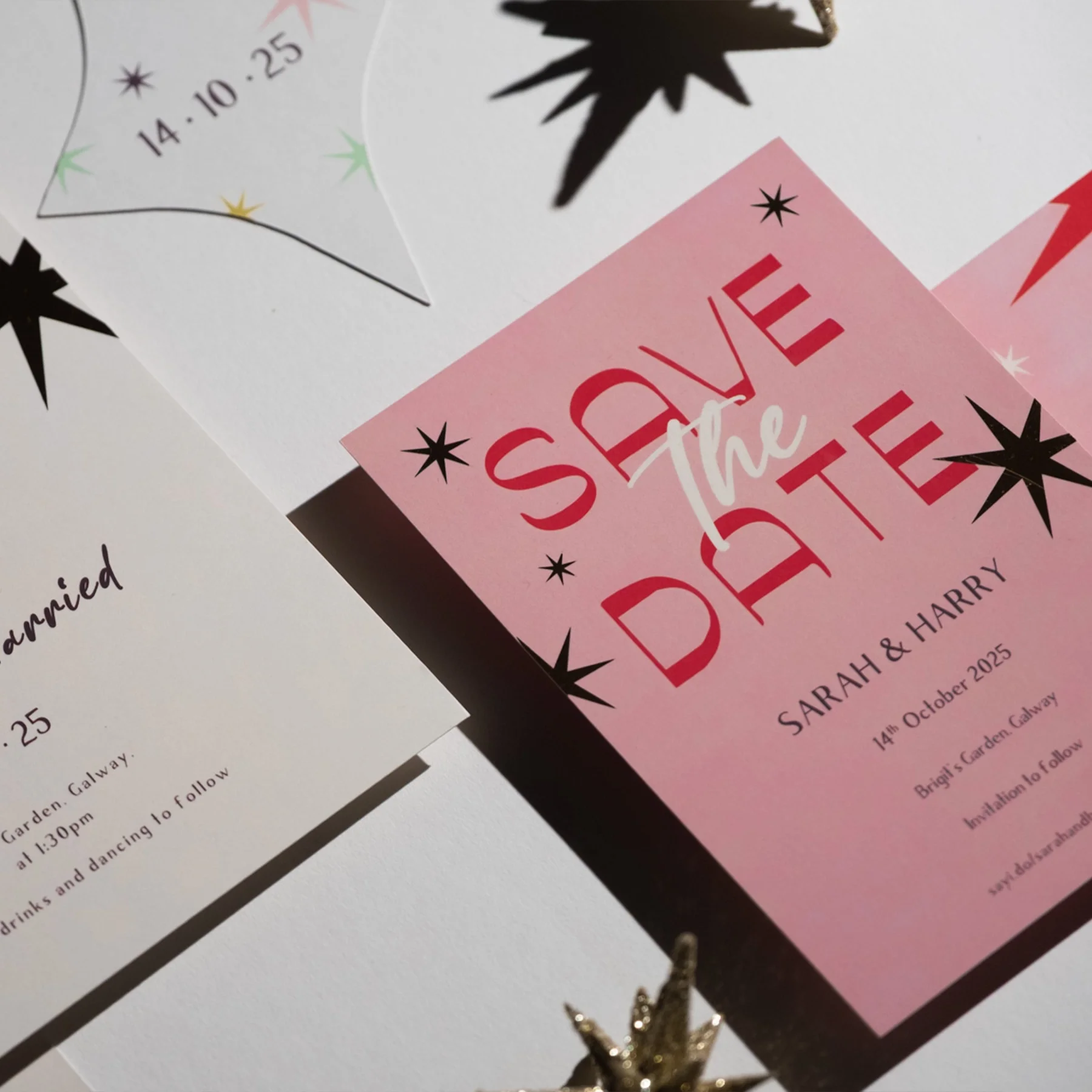 Pink wedding invitation with red and white text and star decorations, reading "Save the Date" for Sarah and Harry's wedding on October 14, 2025, at Bright Garden in Galway.
