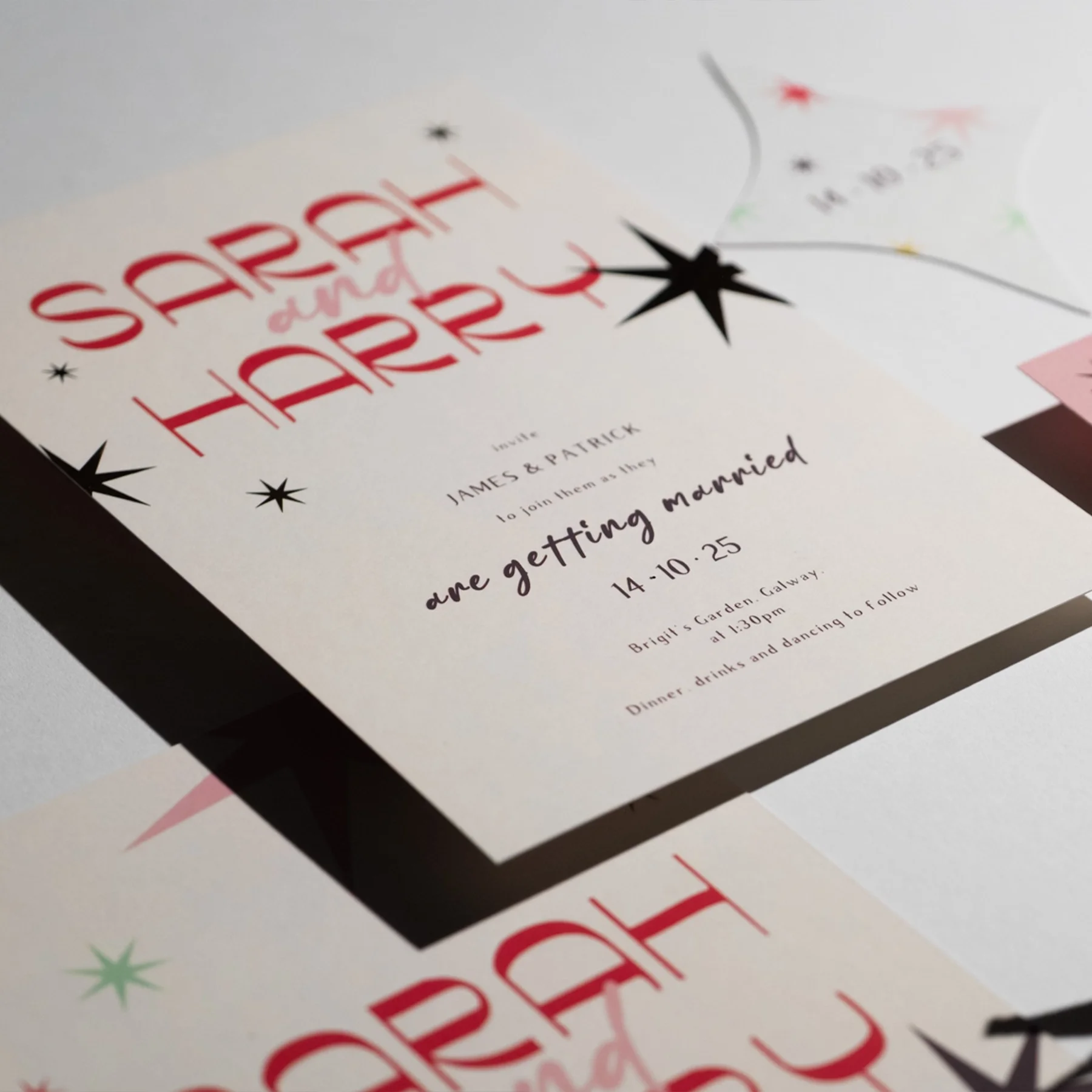 Wedding invitation with black and red star decorations, announcing the wedding of James and Patrick on October 14, 2025, at Brigid's Garden Galway.