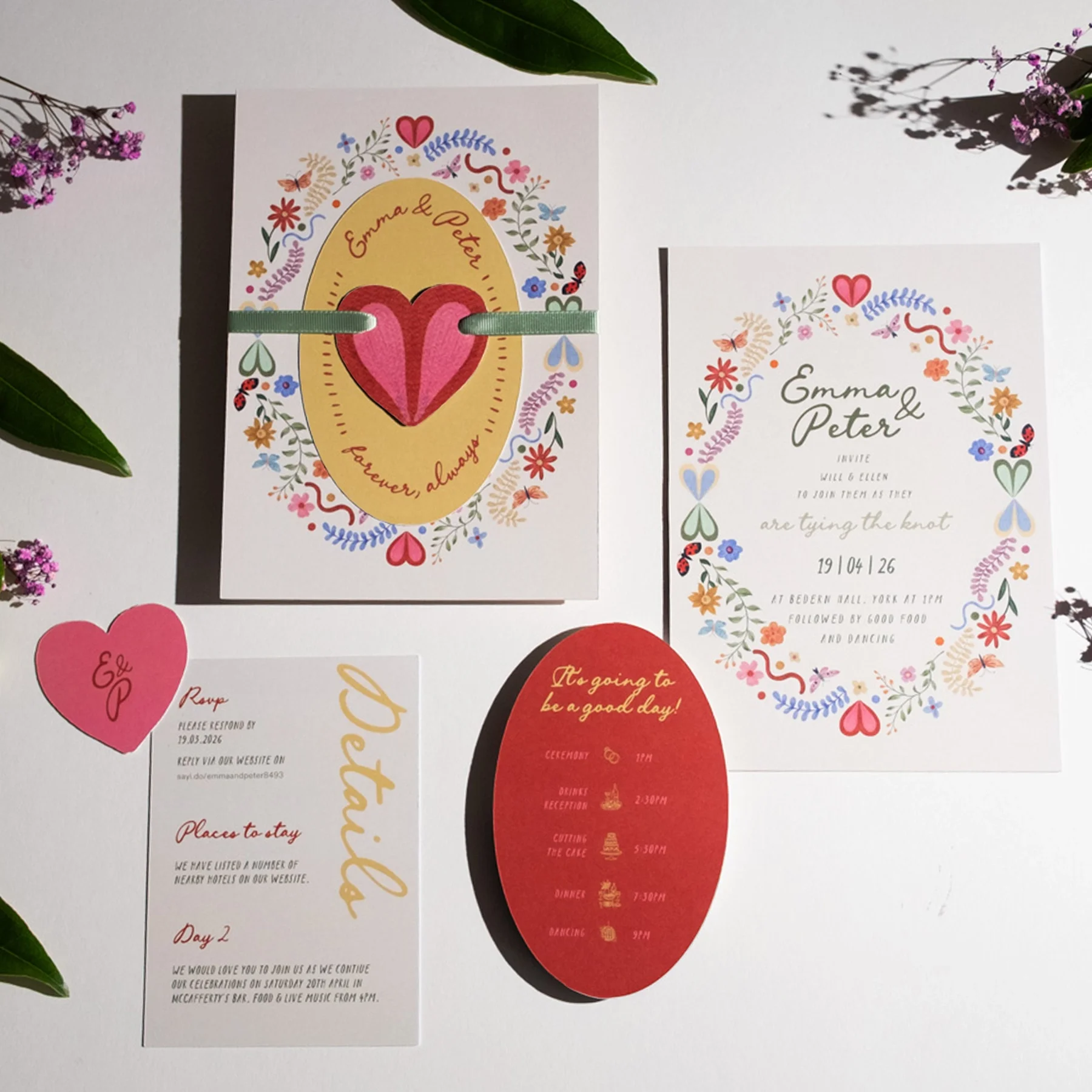 Wedding invitations and cards with floral designs and colorful heart motifs, featuring names Emma and Peter, and details of the event and activities.