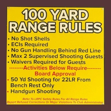 Yellow sign displaying 100-yard range rules, including no shot shells, ECI requirements, no gun handling behind red line, max two supervised shooting guests, waivers for guests, and activities requiring board approval. Also notes 50-yard shooting for 22LR from bench rest and handgun shooting, with a reference to LRPC safety rules.