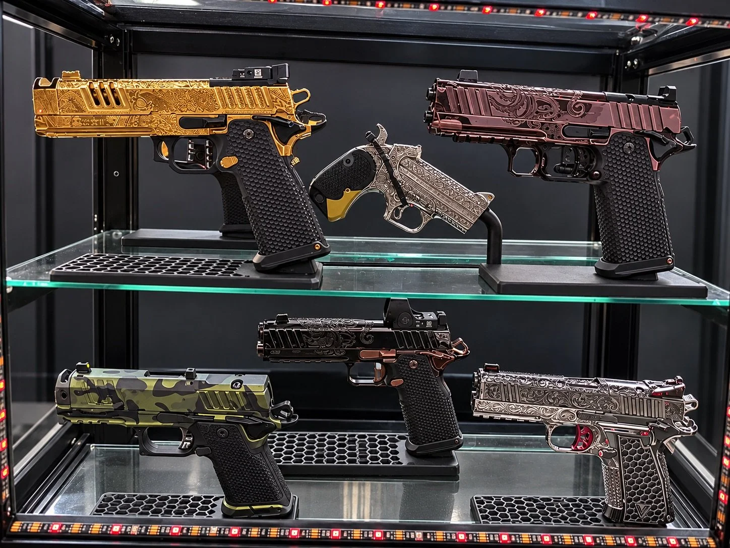 Six custom engraved pistols in a display case