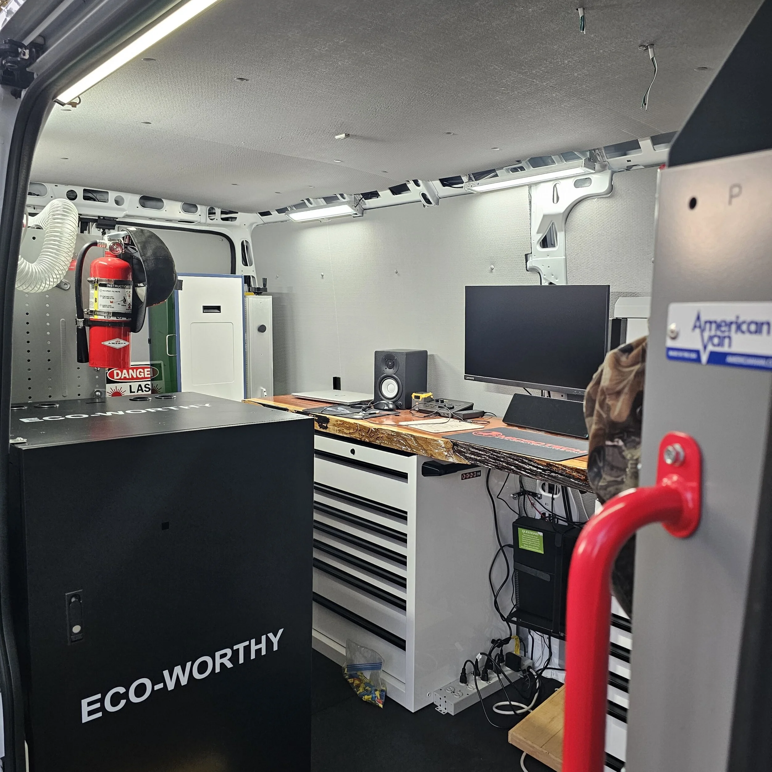 Mobile laser workshop interior with workbench, tool storage and self-contained battery power