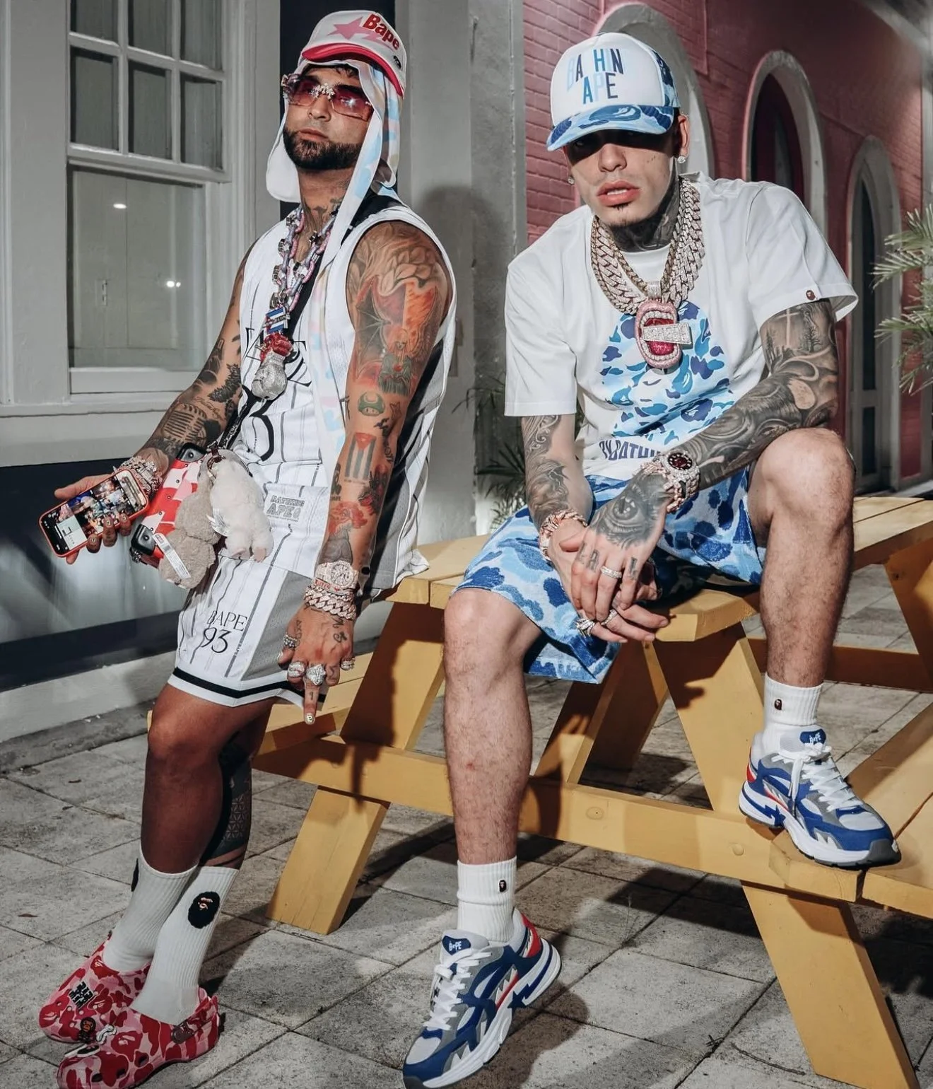 Ovi (Left) in SS25 BAPE Pink STA Trucker Hat, White Reversible Multi Logo Jersey & Shorts, ABC Pink Camo Luggage Crossbody Bag & BAPE x Crocs ABC Pink Camo Clogs