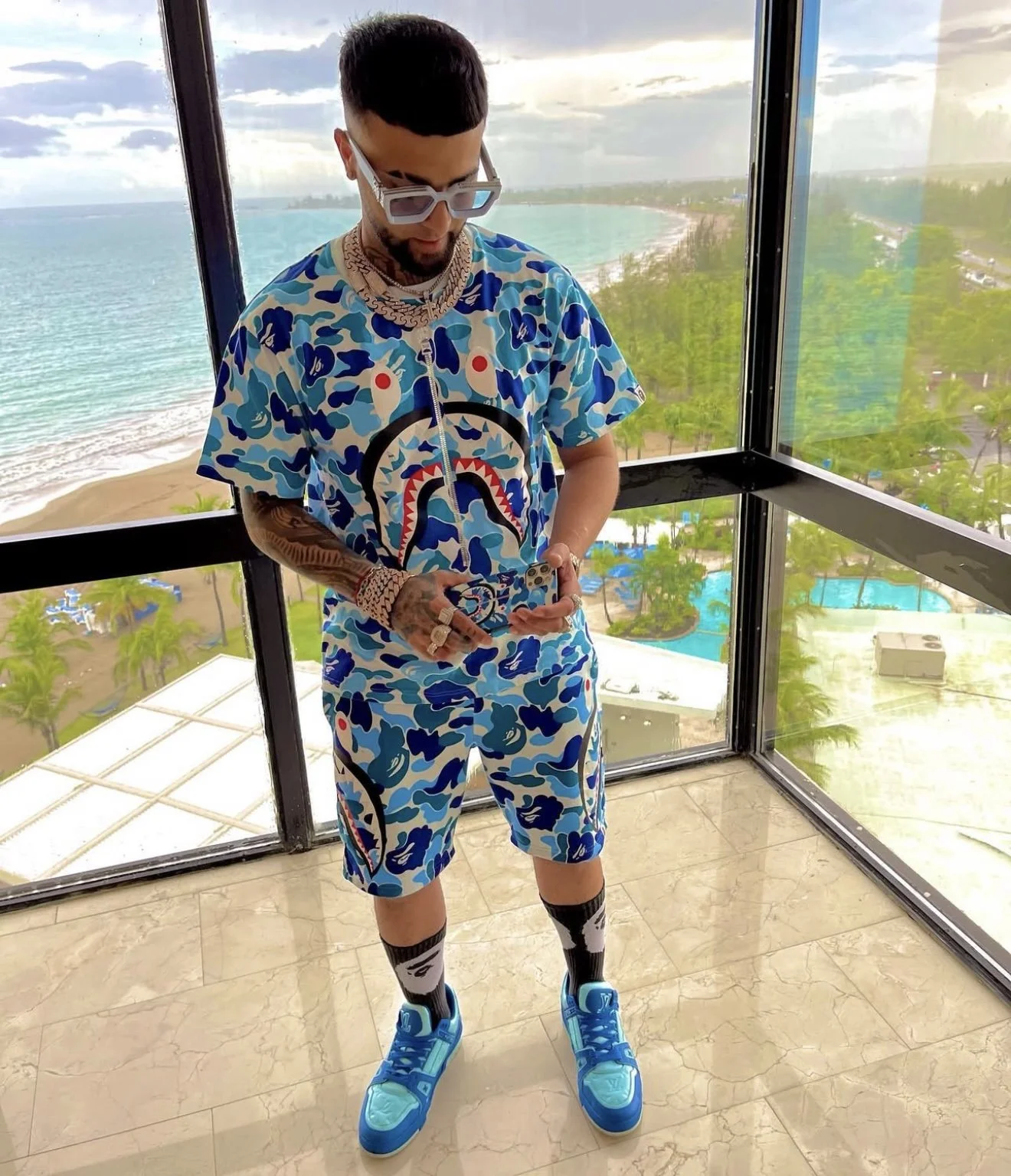 Ovi in SS22 BAPE ABC Camo Blue AOP Shark Face T-Shirt & Side Shark Sweatshorts, Black/White Ape Head Socks and Louis Vuitton LV Trainer Sneakers