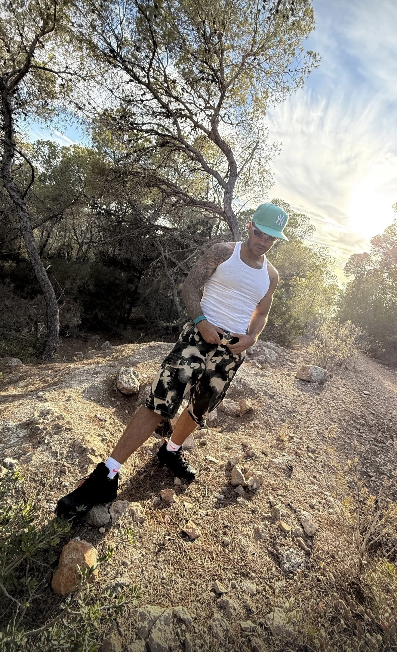 Feid in the SS25 BAPE MAP CAMO GREEN RELAXED FIT CARGO SHORTS