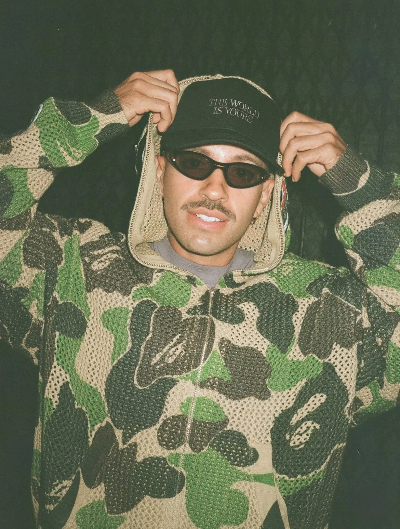 Feid in the SS25 BAPE ABC CAMO GREEN CROCHET RELAXED FIT SHARK HOODIE