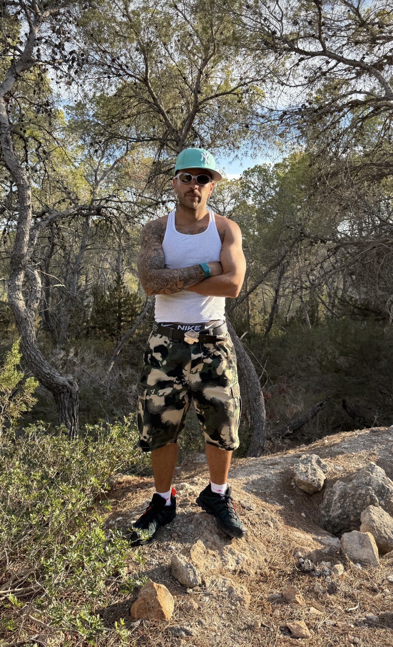 Feid in the SS25 BAPE MAP CAMO GREEN RELAXED FIT CARGO SHORTS