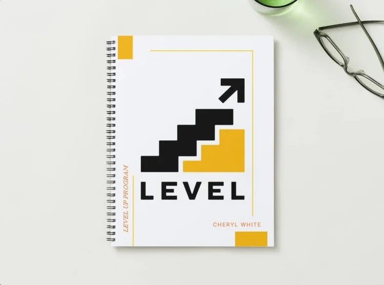 The Level Up Program student workbook, a spiral-bound book with the Level Up staircase logo on a light cover.