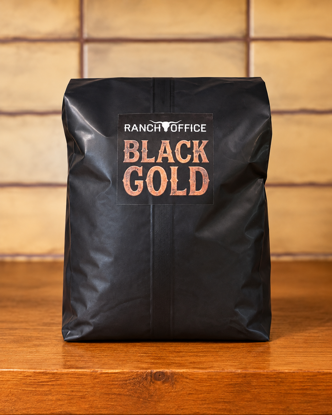 Black bag of Ranch Office Black Gold coffee on a wooden surface.