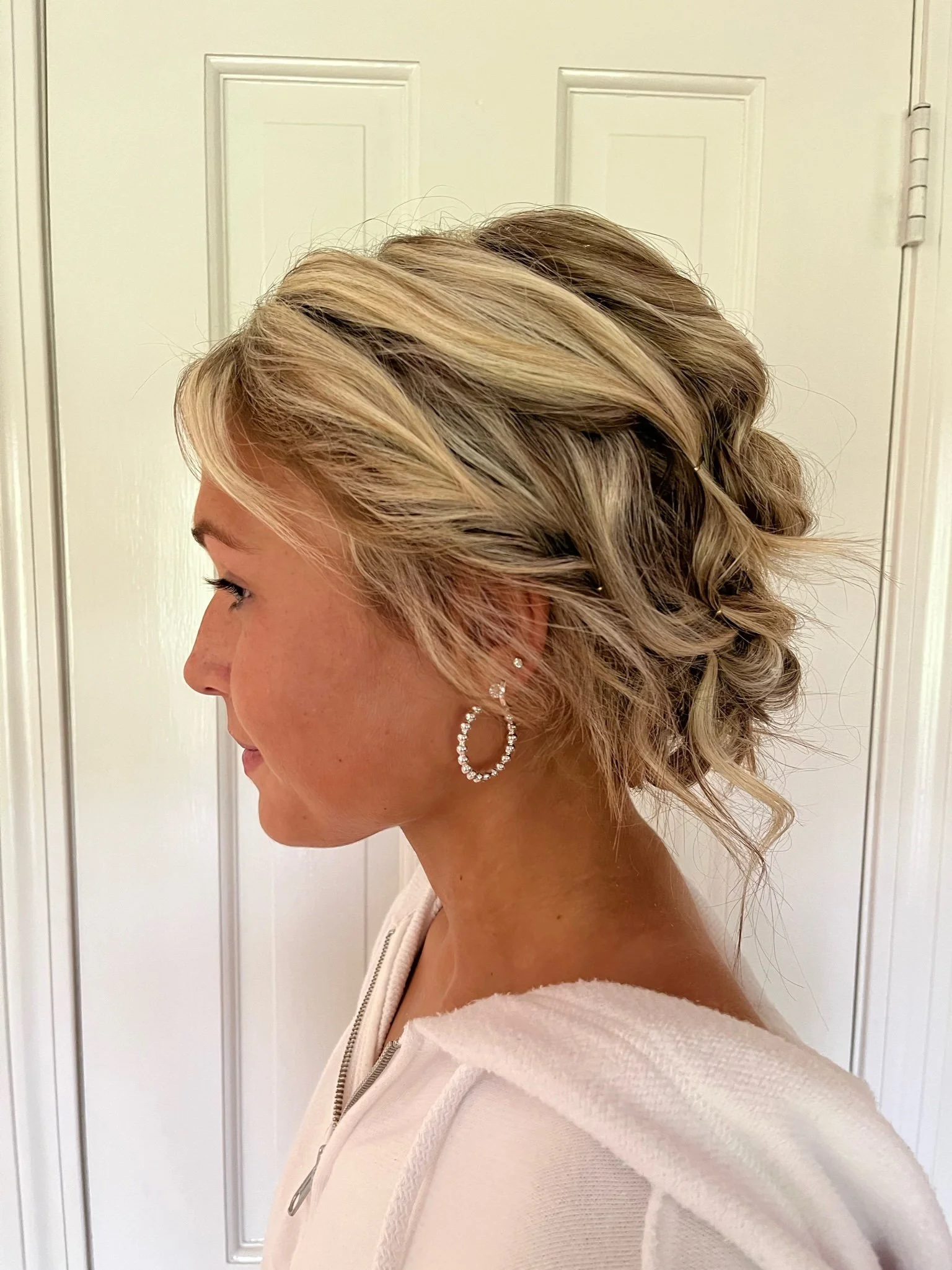 Side view of a bride with her hair in an intricate updo