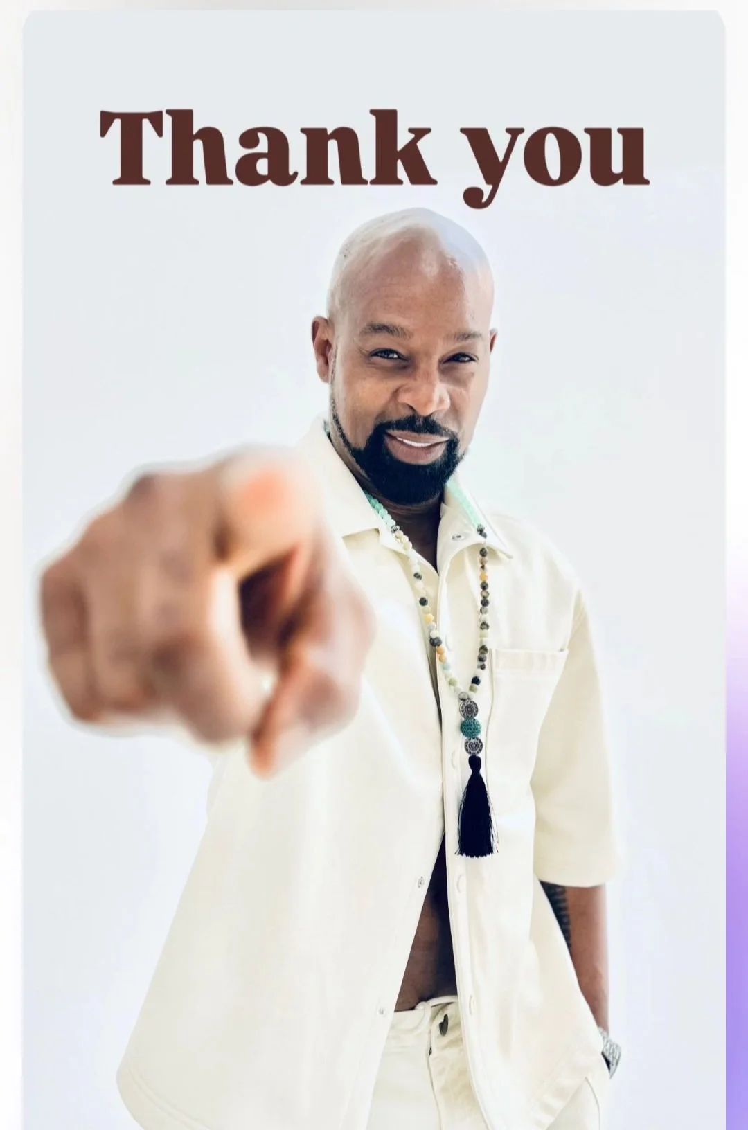 A man pointing at the camera with a smile, wearing a cream-colored shirt, necklace, and watch, with the words "Thank you" in large print at the top.