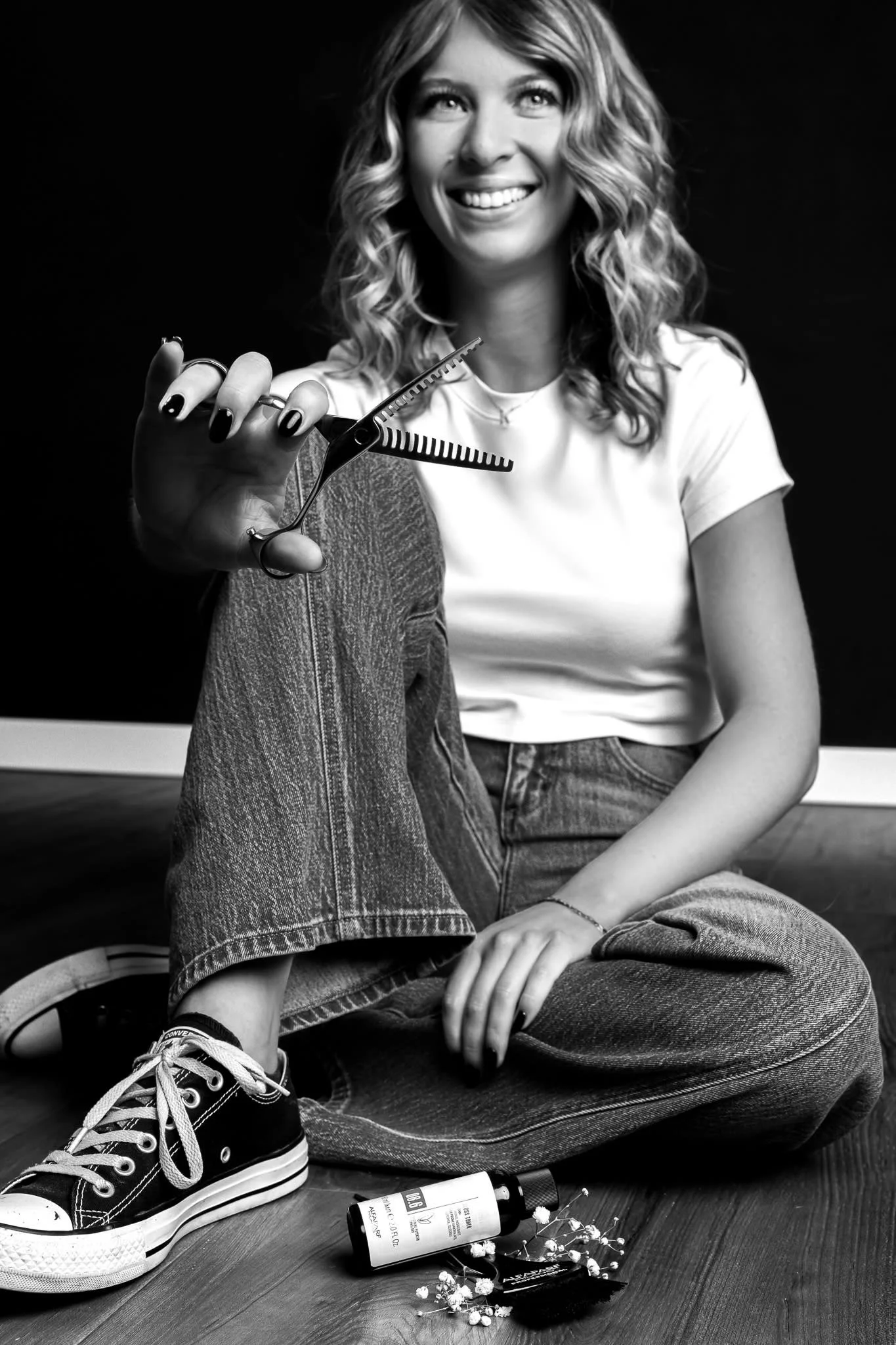 Kaylee, experienced hair stylist and owner of Soar & Strand, smiling at the camera in North Liberty, IA salon
