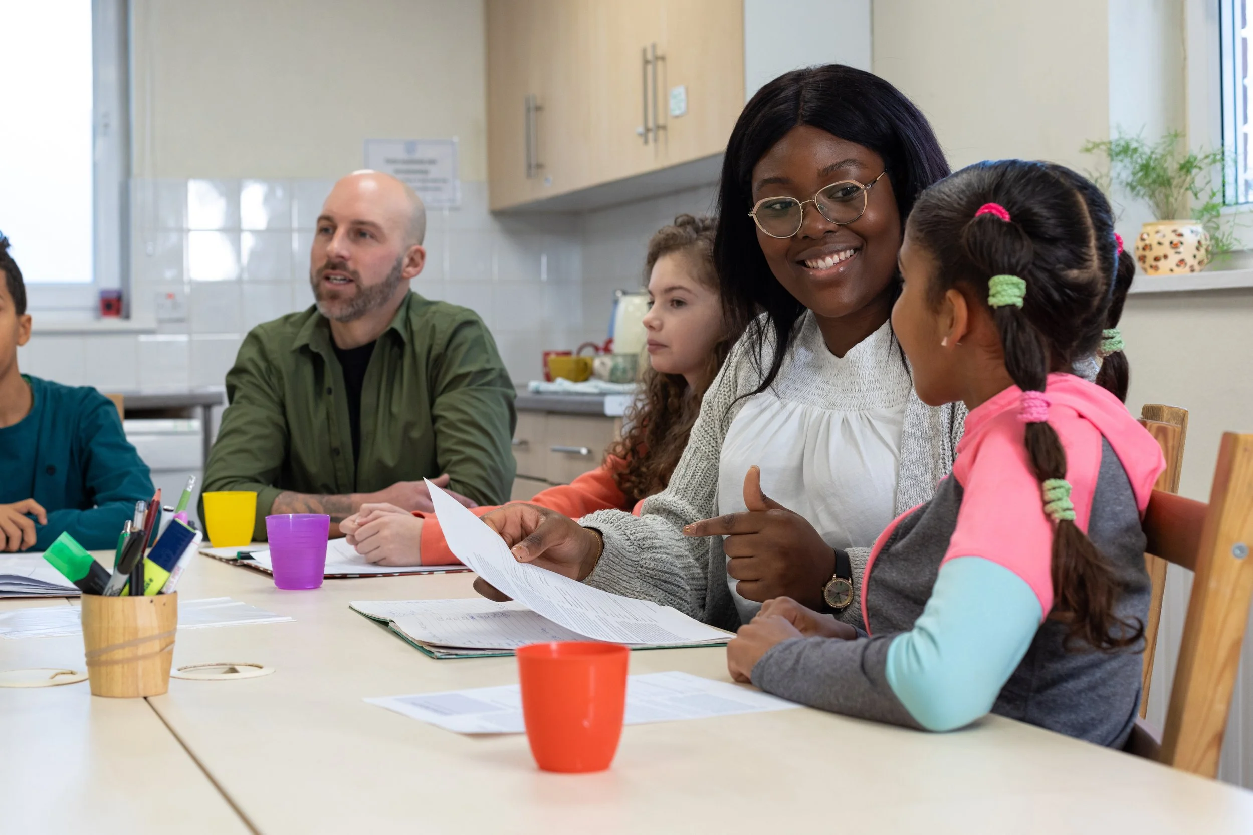 Families sit together at the table for an activity