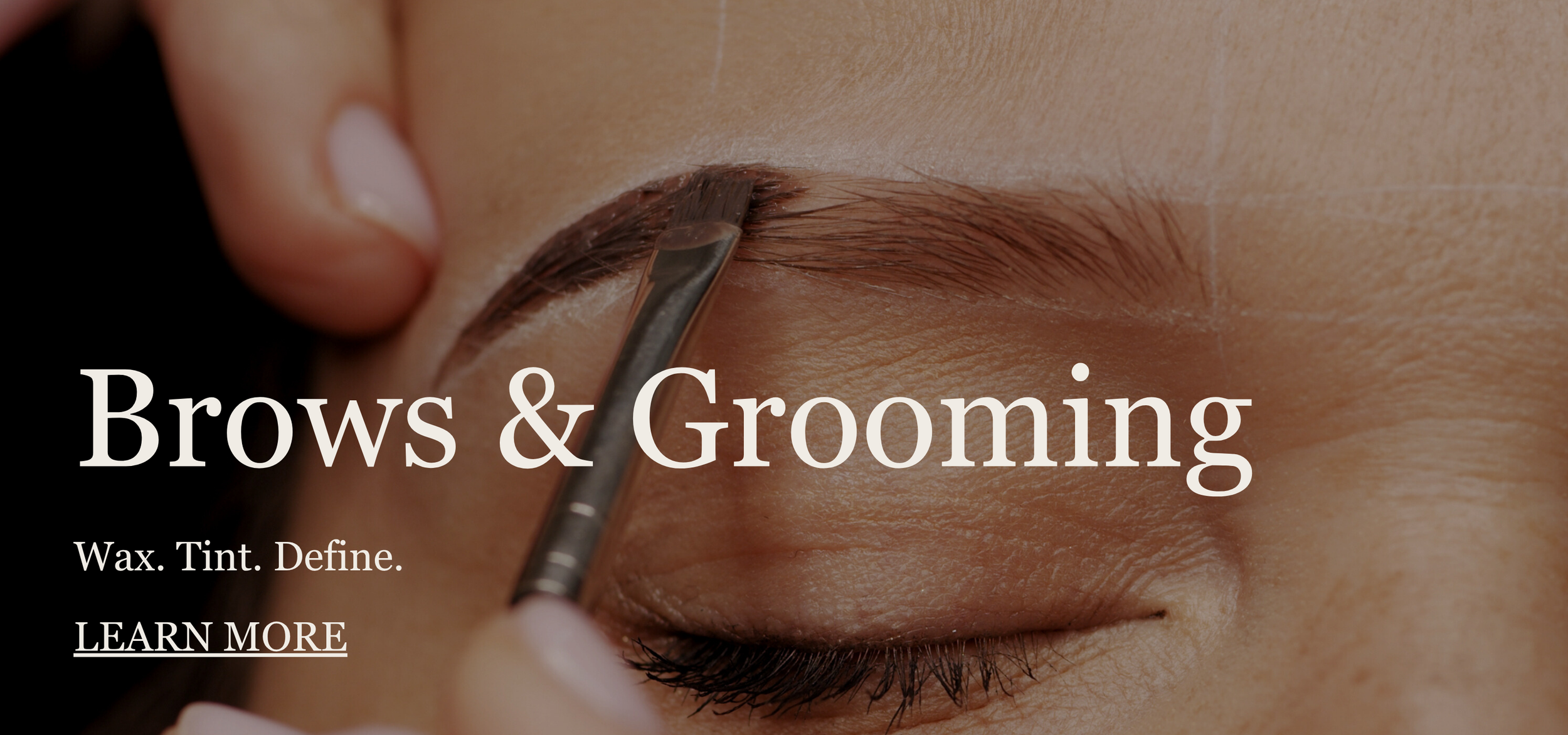 Close-up of a person grooming their eyebrow with a tweezer, focusing on the eyebrow area.