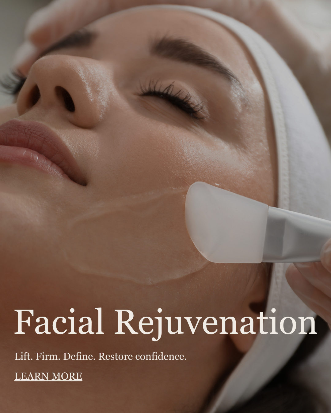 A woman receiving facial treatment with a device on her cheek, her eyes closed, in a spa or skincare clinic.