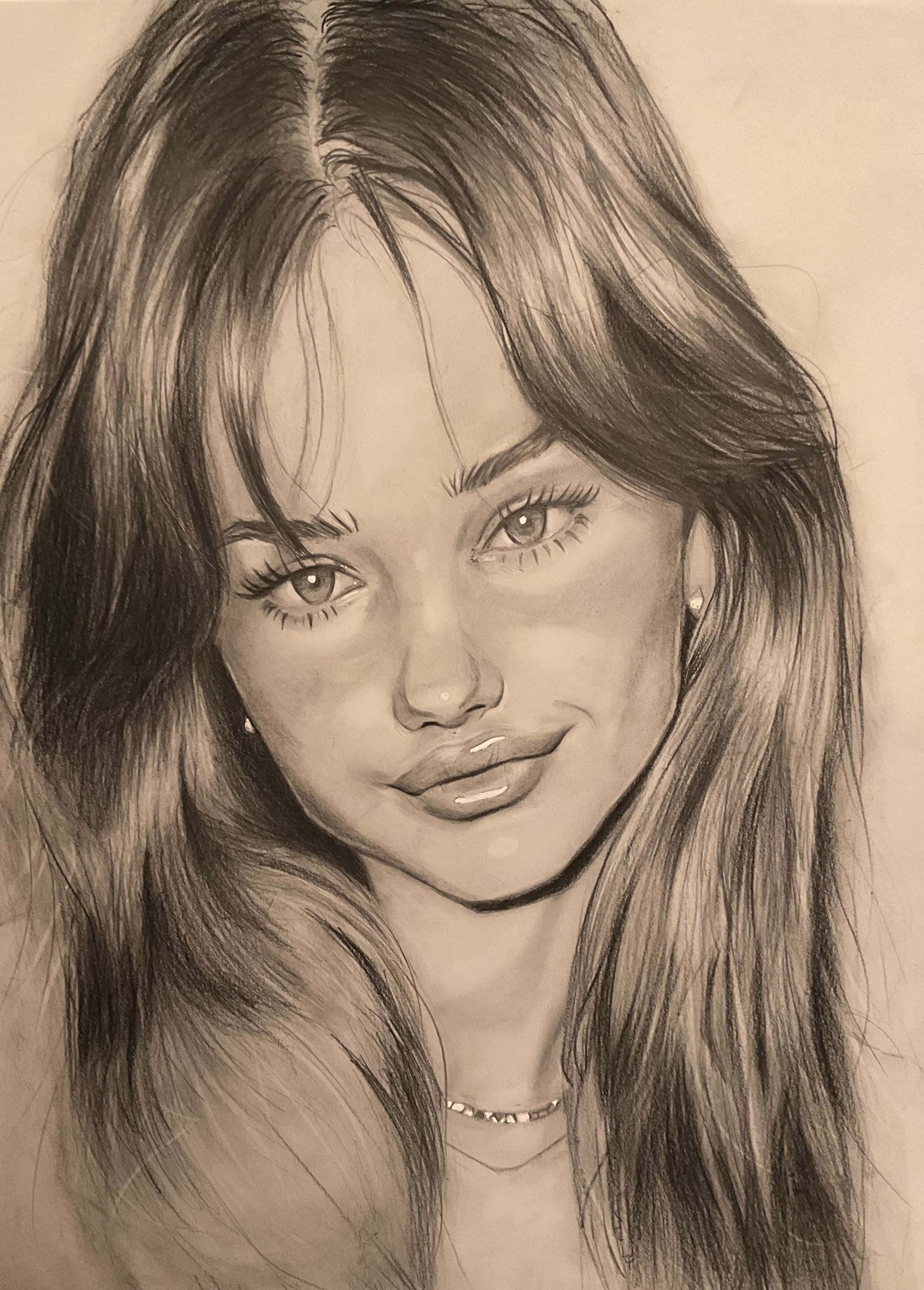 A detailed pencil sketch of a woman with long flowing hair, full lips, and large expressive eyes, wearing a chain necklace and small earrings.