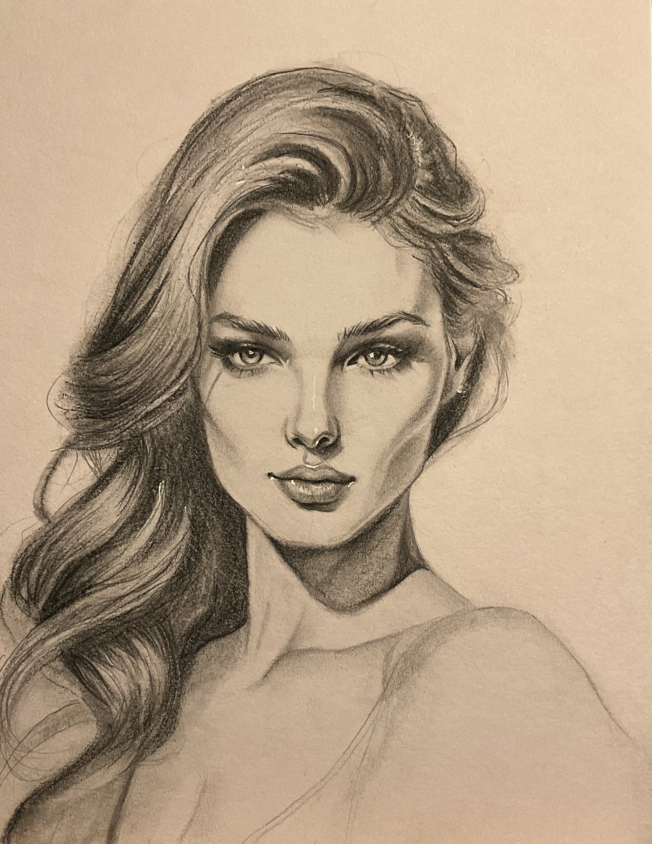 A detailed pencil sketch of a woman with long, wavy hair, intense eyes, full lips, and defined facial features, with a partial view of her shoulder.