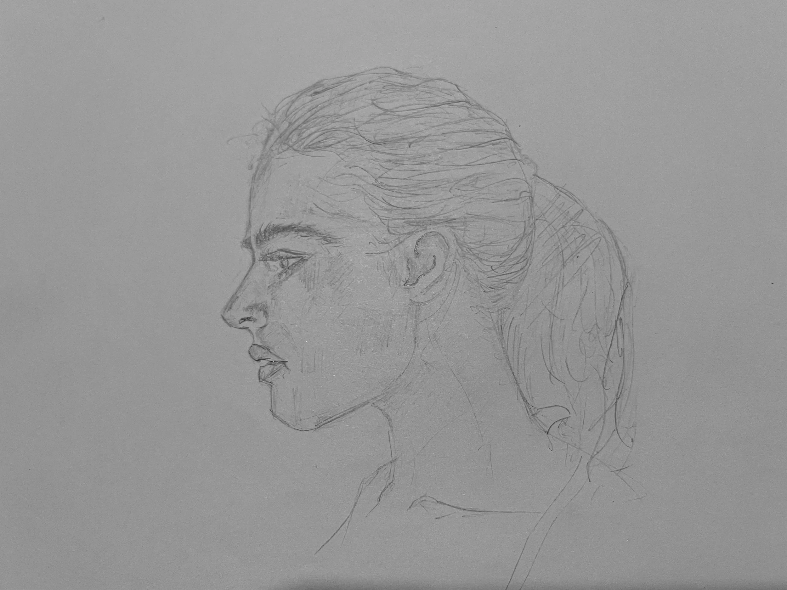 Graphite profile drawing of a woman in side view, focused on head structure, proportions, and clean linework.
