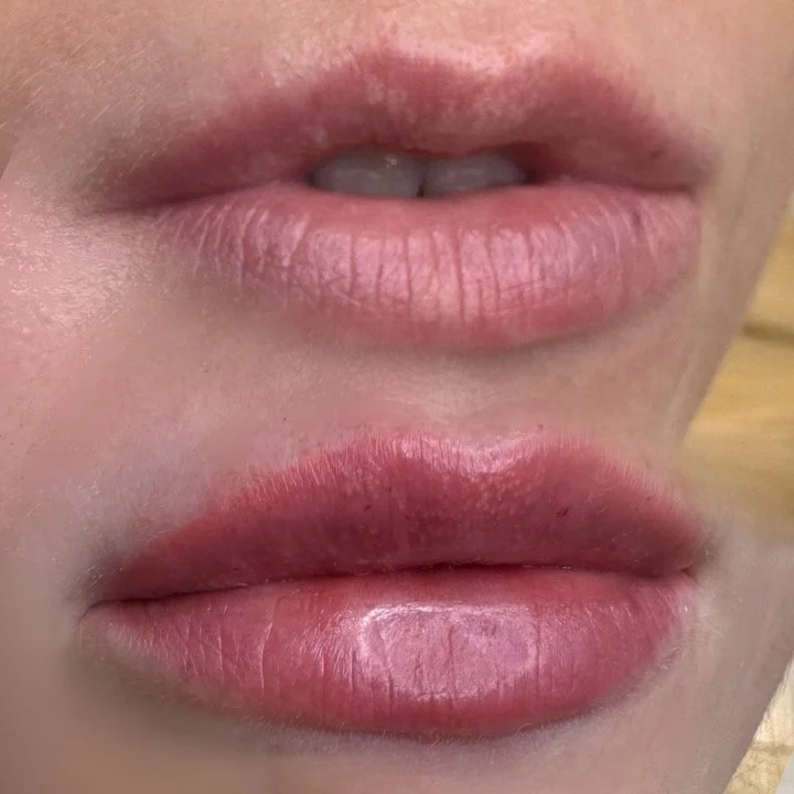 Close-up of a person's lips, showing two sets of lips, one above the other.