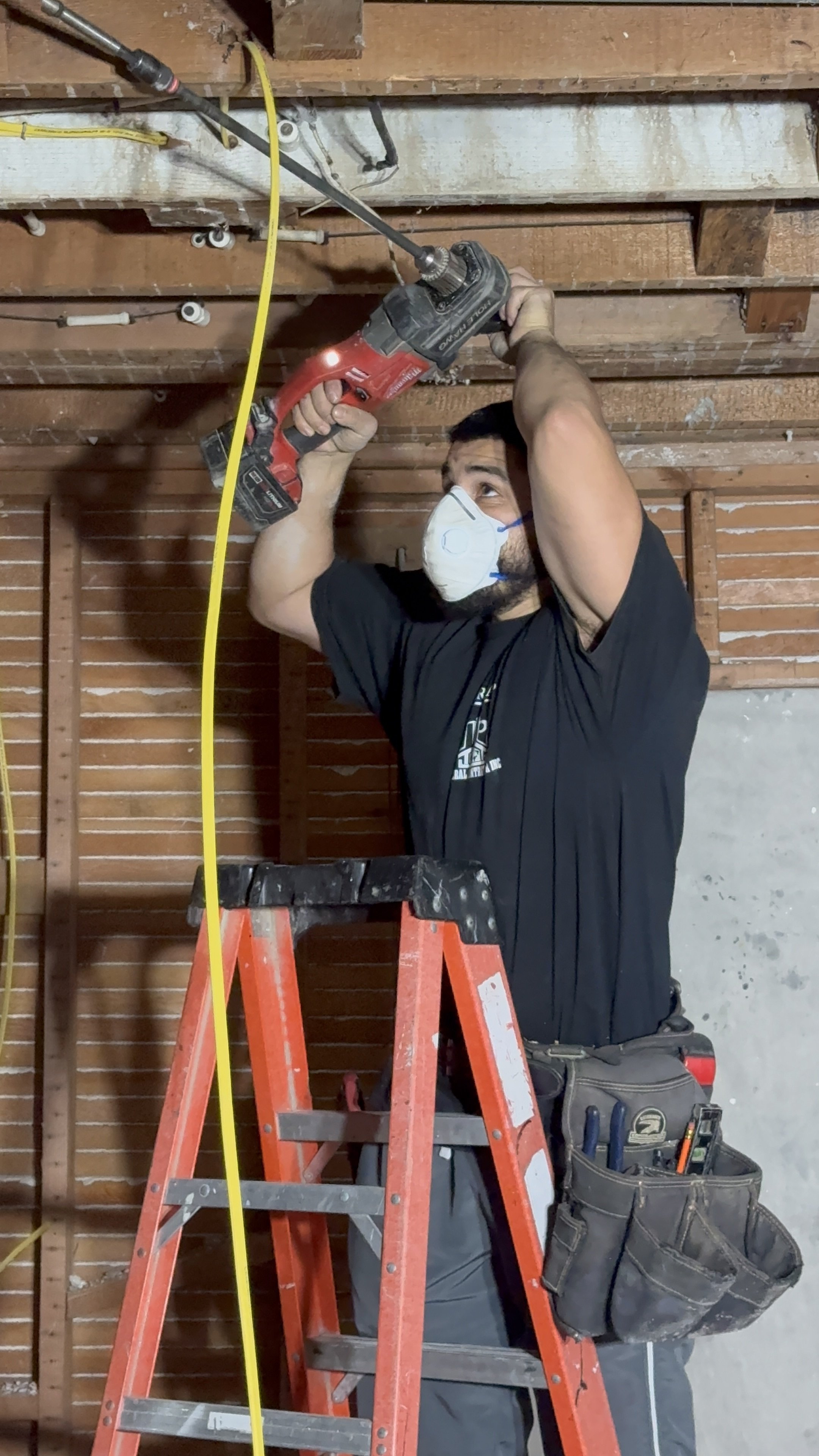 Man with tools  drilling doing eletricial work