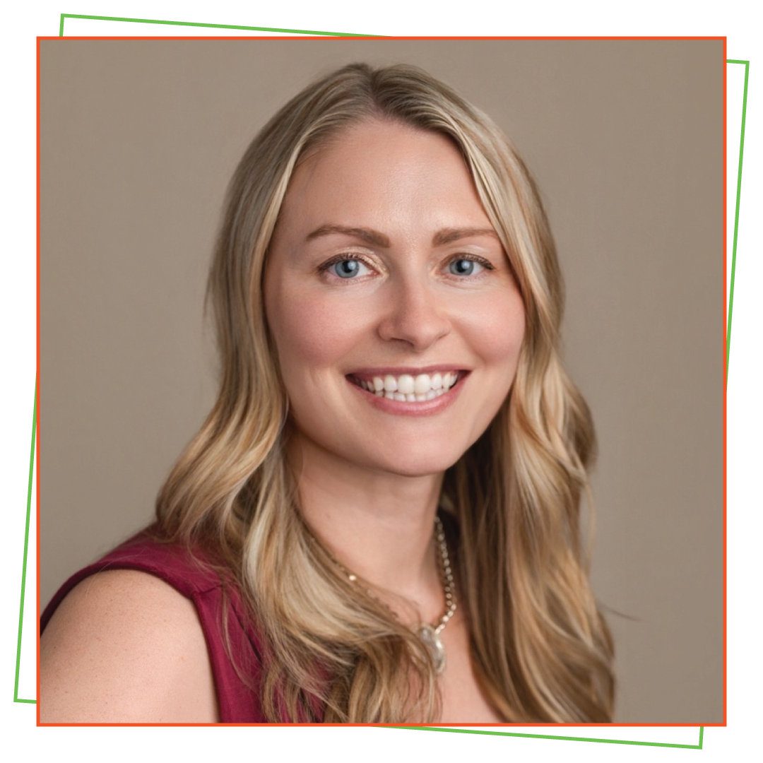 A smiling woman with long blonde hair, blue eyes, wearing a sleeveless maroon top and a pearl necklace, against a neutral background.