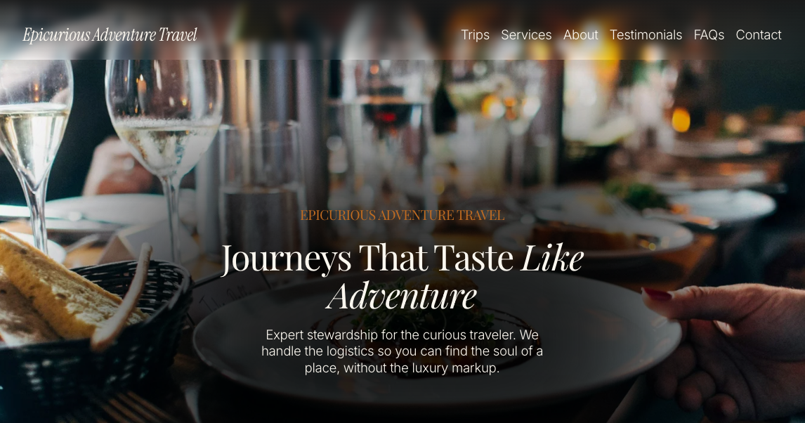 Screenshot of the website homepage for Epicurious Adventure Travel featuring a dining scene with wine glasses, a basket of bread, and blurred plates on a table, with navigation menu at the top.